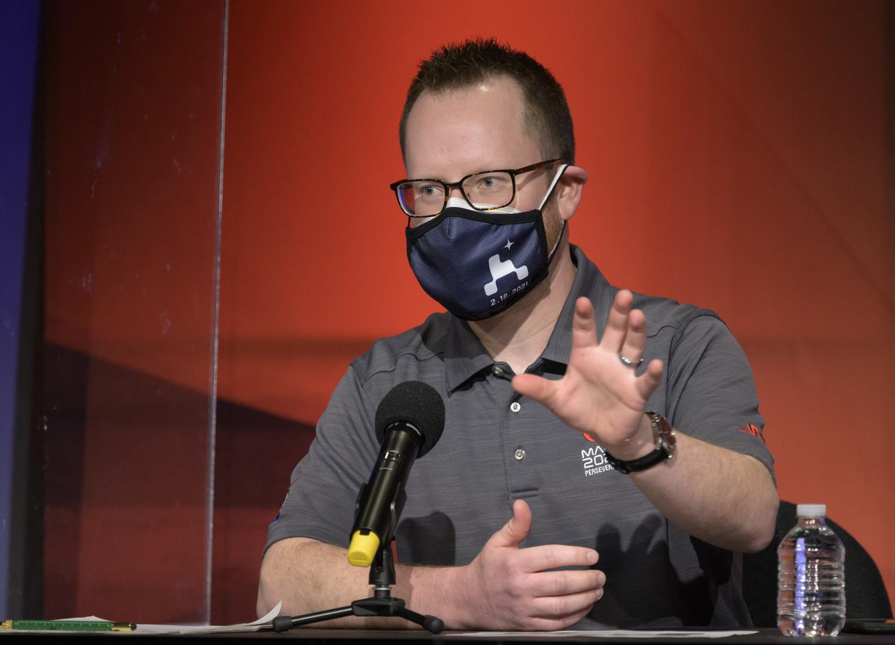 Deputy Phase Lead for Entry, Descent, and Landing Aaron Stehura, gives remarks during a NASA Perseverance rover initial surface checkout briefing, Friday Feb. 19, 2021, at NASA's Jet Propulsion Laboratory in Pasadena, California. The Perseverance Mars rover landed on Mars Thursday, Feb. 18, 2021. A key objective for Perseverance’s mission on Mars is astrobiology, including the search for signs of ancient microbial life. The rover will characterize the planet’s geology and past climate, pave the way for human exploration of the Red Planet, and be the first mission to collect and cache Martian rock and regolith. Photo Credit: (NASA/Bill Ingalls)
