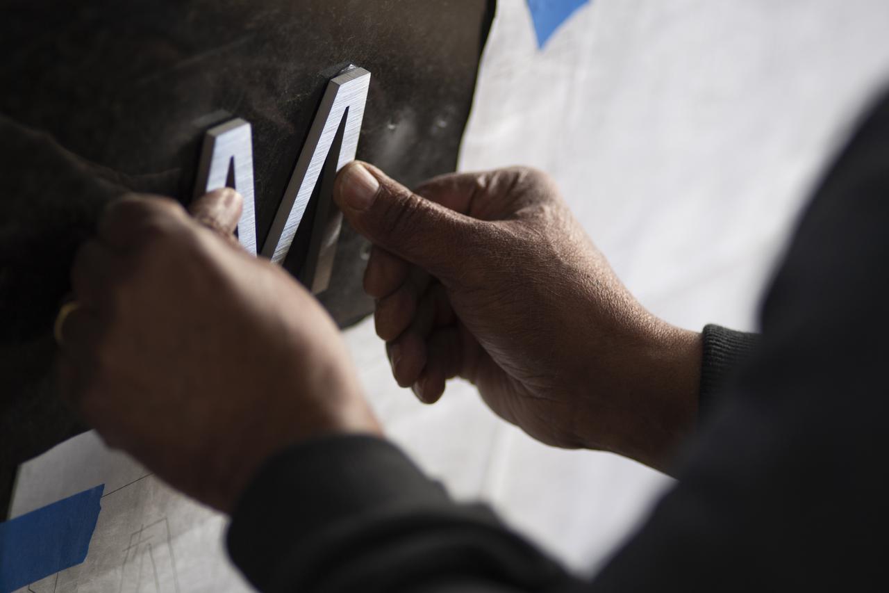 The Mary W. Jackson NASA Headquarters sign is installed ahead of the building naming ceremony, Thursday, Feb. 25, 2021, at NASA Headquarters in Washington, DC. Mary W. Jackson, the first African American female engineer at NASA, began her career with the agency in the segregated West Area Computing Unit of NASA’s Langley Research Center in Hampton, Virginia. The mathematician and aerospace engineer went on to lead programs influencing the hiring and promotion of women in NASA's science, technology, engineering, and mathematics careers. In 2019, she posthumously received the Congressional Gold Medal. Photo Credit: (NASA/Joel Kowsky)