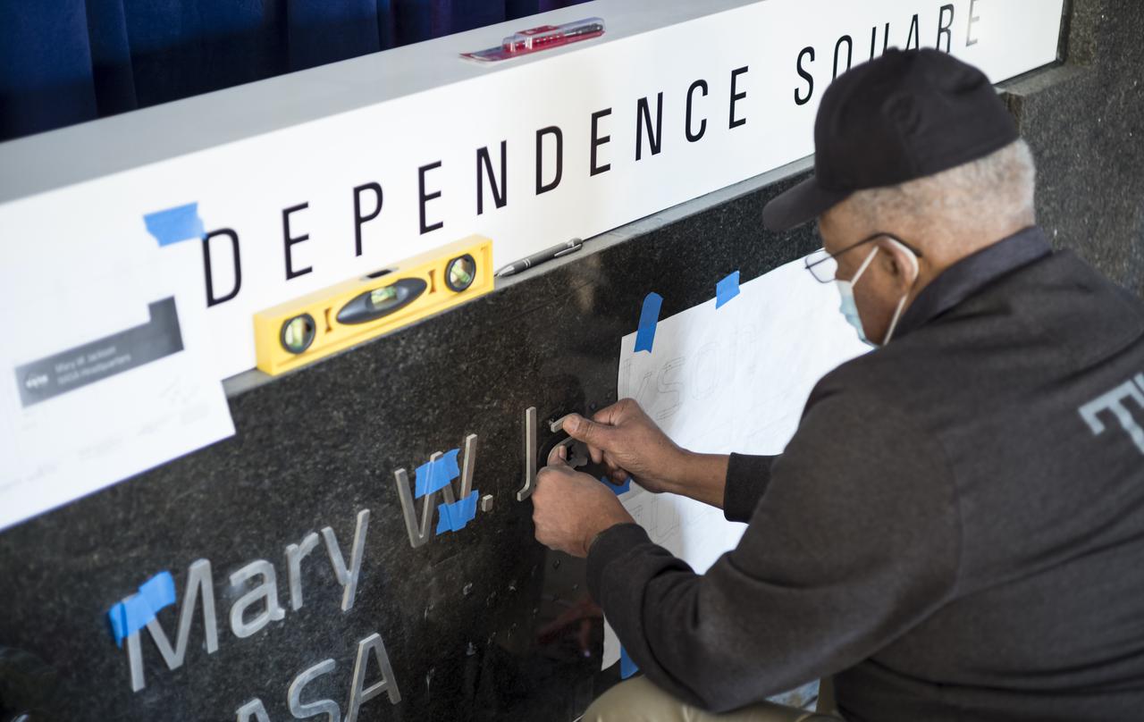The Mary W. Jackson NASA Headquarters sign is installed ahead of the building naming ceremony, Thursday, Feb. 25, 2021, at NASA Headquarters in Washington, DC. Mary W. Jackson, the first African American female engineer at NASA, began her career with the agency in the segregated West Area Computing Unit of NASA’s Langley Research Center in Hampton, Virginia. The mathematician and aerospace engineer went on to lead programs influencing the hiring and promotion of women in NASA's science, technology, engineering, and mathematics careers. In 2019, she posthumously received the Congressional Gold Medal. Photo Credit: (NASA/Joel Kowsky)