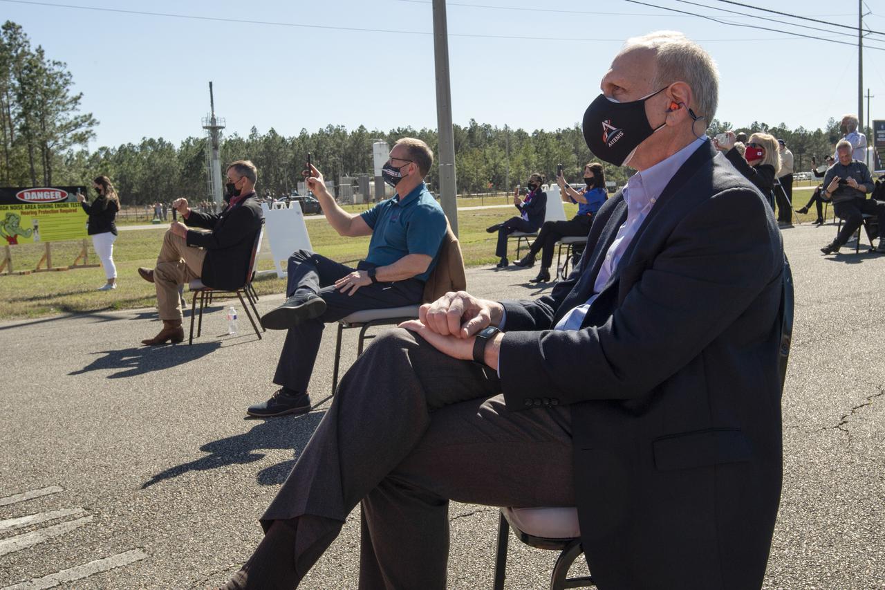Acting NASA Administrator Steve Jurczyk, right, and Rick Gilbrech, director of NASA's Stennis Space Center, center, watch as the core stage for the first flight of NASA’s Space Launch System rocket undergoes a second hot fire test in the B-2 Test Stand, Thursday, March 18, 2021, at NASA’s Stennis Space Center near Bay St. Louis, Mississippi. The four RS-25 engines fired for the full-duration of 8 minutes during the test and generated 1.6 million pounds of thrust. The hot fire test is the final stage of the Green Run test series, a comprehensive assessment of the Space Launch System’s core stage prior to launching the Artemis I mission to the Moon. Photo Credit: (NASA/Robert Markowitz)