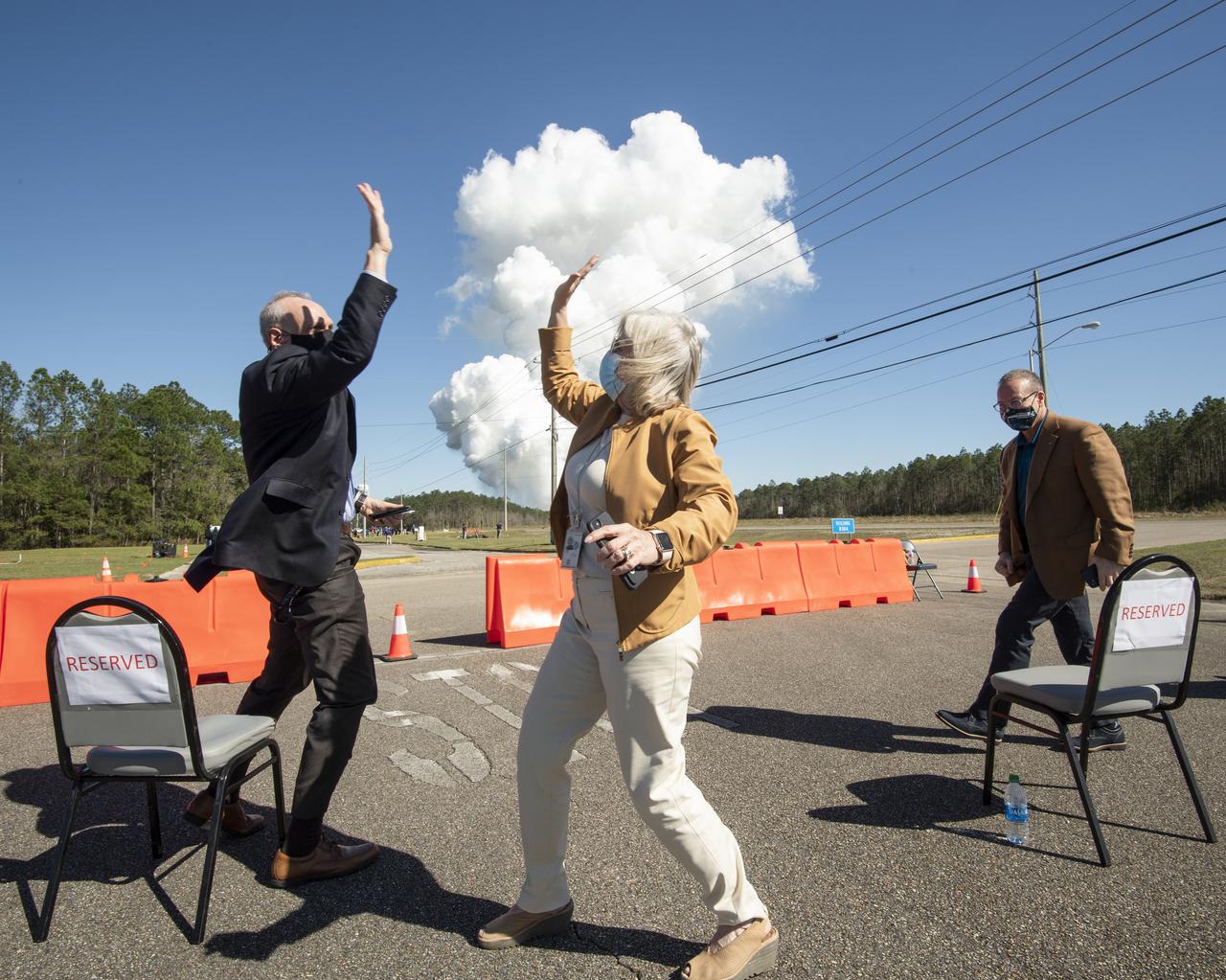 Acting NASA Administrator Steve Jurczyk, left, and Jody Singer, director of NASA's Marshall Space Flight Center, right, high five following a second hot fire test of the core stage for the first flight of NASA’s Space Launch System rocket in the B-2 Test Stand, Thursday, March 18, 2021, at NASA’s Stennis Space Center near Bay St. Louis, Mississippi. The four RS-25 engines fired for the full-duration of 8 minutes during the test and generated 1.6 million pounds of thrust. The hot fire test is the final stage of the Green Run test series, a comprehensive assessment of the Space Launch System’s core stage prior to launching the Artemis I mission to the Moon. Photo Credit: (NASA/Robert Markowitz)