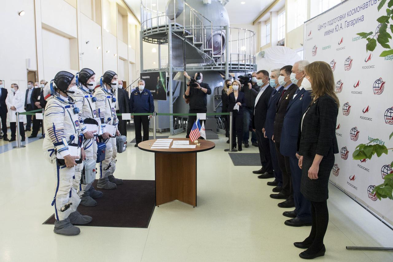 Expedition 65 crew members NASA astronaut Mark Vande Hei, left, Russian cosmonaut Oleg Novitskiy of Roscosmos, center, and Russian cosmonaut Pyotr Dubrov of Roscosmos meet with mission managers ahead of their Soyuz qualification exams, Saturday, March 20, 2021 at the Gagarin Cosmonaut Training Center (GCTC) in Star City, Russia, in advance of their scheduled launch April 9 from Baikonur Cosmodrome in Kazakhstan to the International Space Station. Photo Credit: (NASA/GCTC/Andrey Shelepin)