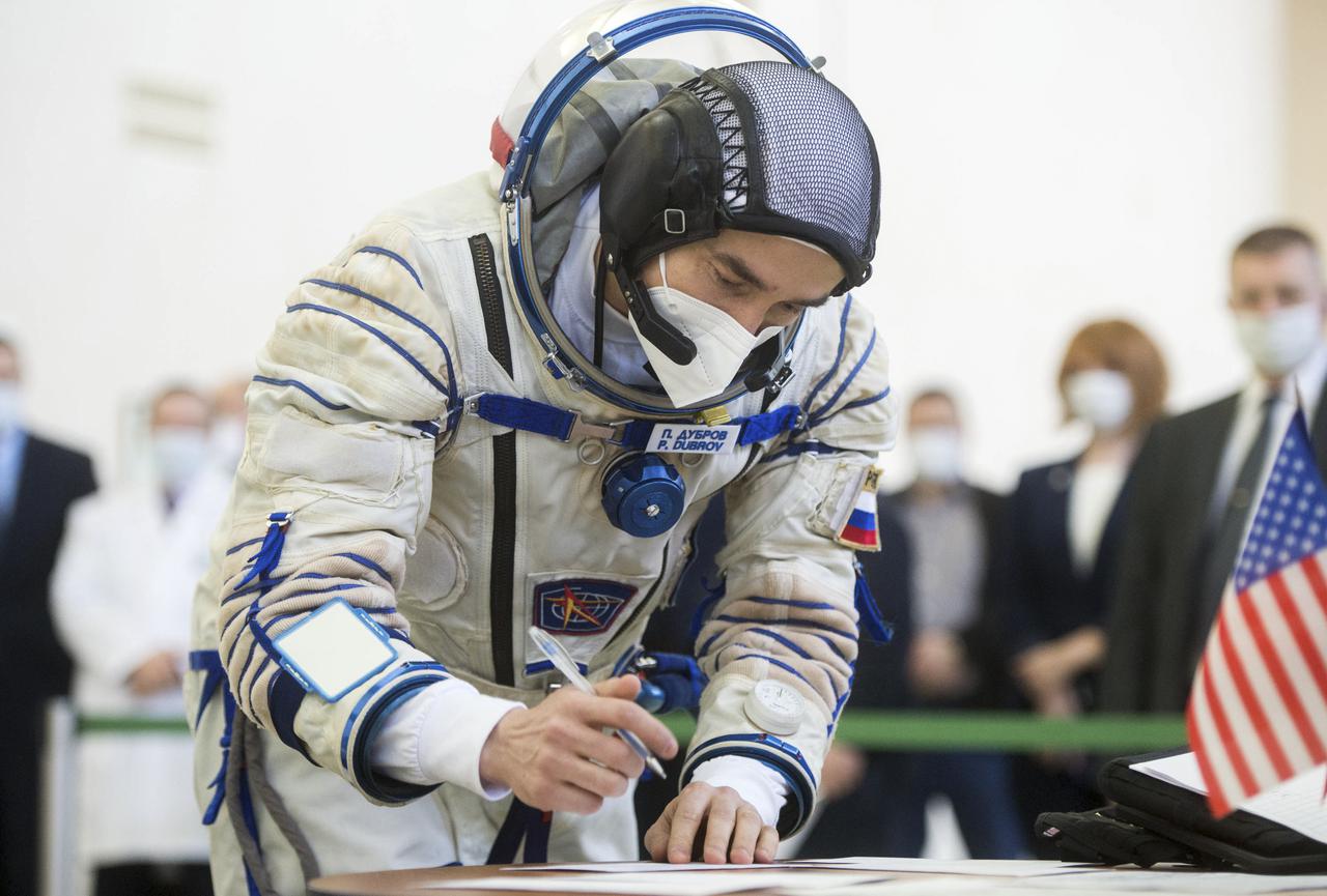 Expedition 65 crew member Pyotr Dubrov of Roscosmos, signs in for Soyuz qualification exams Saturday, March 20, 2021 at the Gagarin Cosmonaut Training Center (GCTC) in Star City, Russia, in advance of his scheduled launch April 9 from Baikonur Cosmodrome in Kazakhstan to the International Space Station. Photo Credit: (NASA/GCTC/Andrey Shelepin)