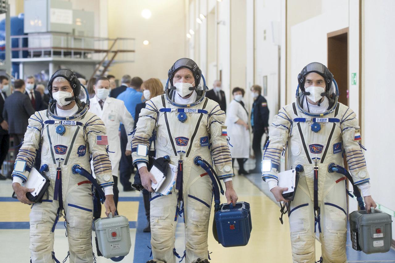 Expedition 65 crew members NASA astronaut Mark Vande Hei, left, Russian cosmonaut Oleg Novitskiy of Roscosmos, center, and Russian cosmonaut Pyotr Dubrov of Roscosmos arrive for Soyuz qualification exams iptcdow}, March 20, 2021 at the Gagarin Cosmonaut Training Center (GCTC) in Star City, Russia, in advance of their scheduled launch April 9 from Baikonur Cosmodrome in Kazakhstan to the International Space Station. Photo Credit: (NASA/GCTC/Andrey Shelepin)
