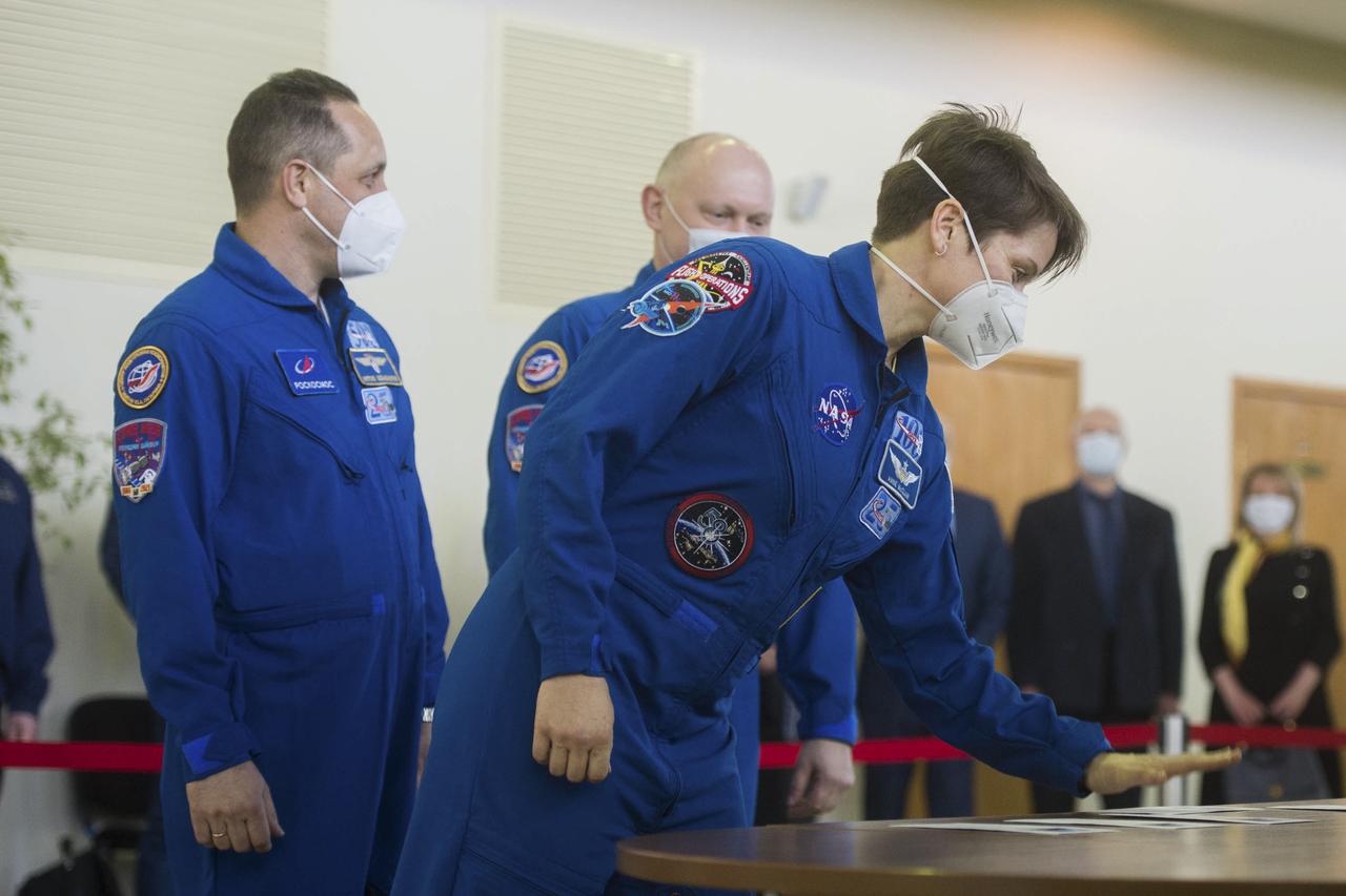 Expedition 65 backup crew member NASA astronaut Anne McClain signs in for Soyuz qualification exams while Russian cosmonaut Anton Shkaplerov of Roscosmos, left, and Russian cosmonaut Oleg Artemyev of Roscosmos look on, Saturday, March 20, 2021 at the Gagarin Cosmonaut Training Center (GCTC) in Star City, Russia, in advance of the Expedition 65 launch April 9 from Baikonur Cosmodrome in Kazakhstan to the International Space Station. Photo Credit: (NASA/GCTC/Andrey Shelepin)