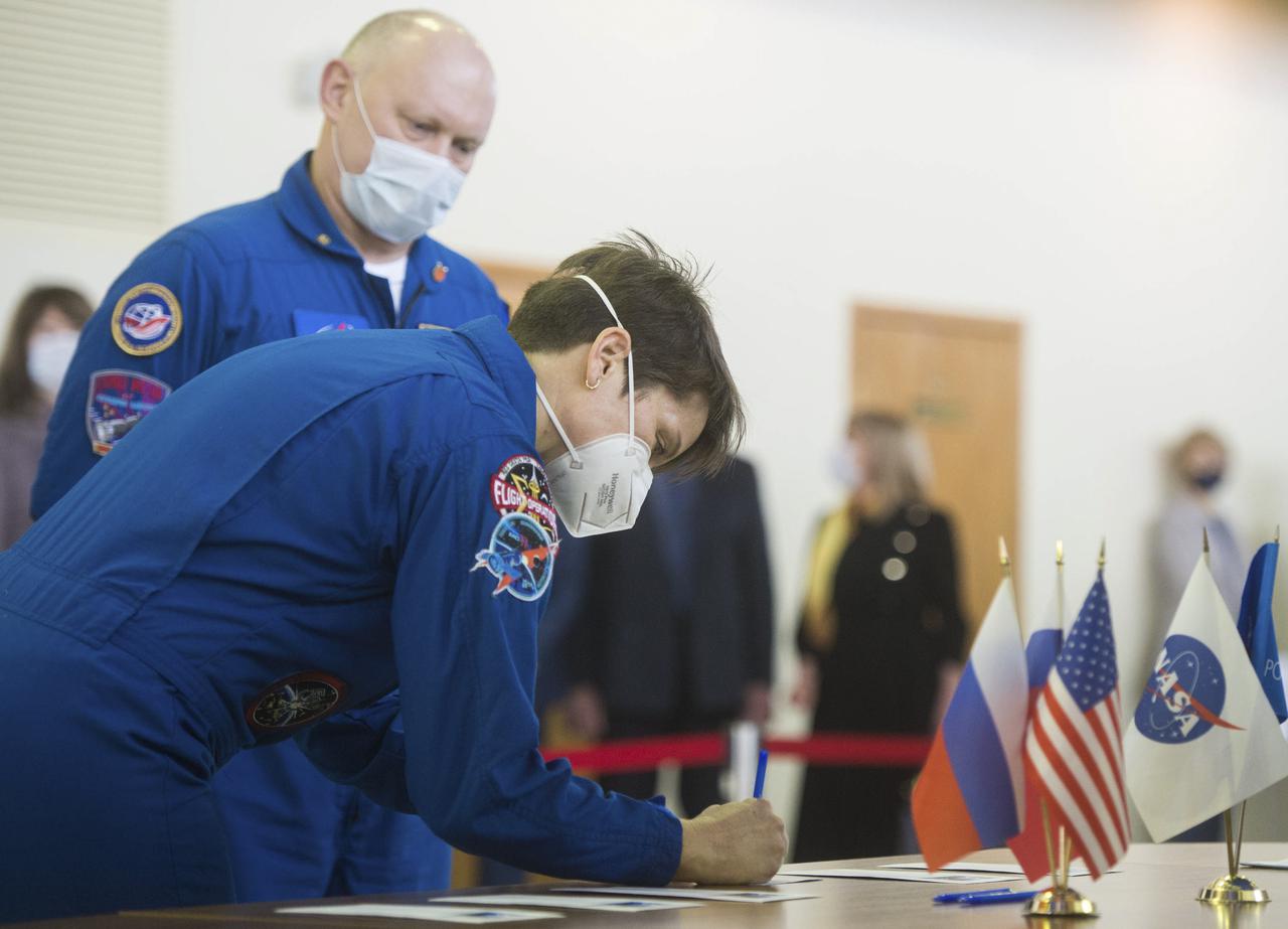 Expedition 65 backup crew member NASA astronaut Anne McClain signs in for Soyuz qualification exams while Russian cosmonaut Oleg Artemyev of Roscosmos looks on, Saturday, March 20, 2021 at the Gagarin Cosmonaut Training Center (GCTC) in Star City, Russia, in advance of the Expedition 65 launch April 9 from Baikonur Cosmodrome in Kazakhstan to the International Space Station. Photo Credit: (NASA/GCTC/Andrey Shelepin)
