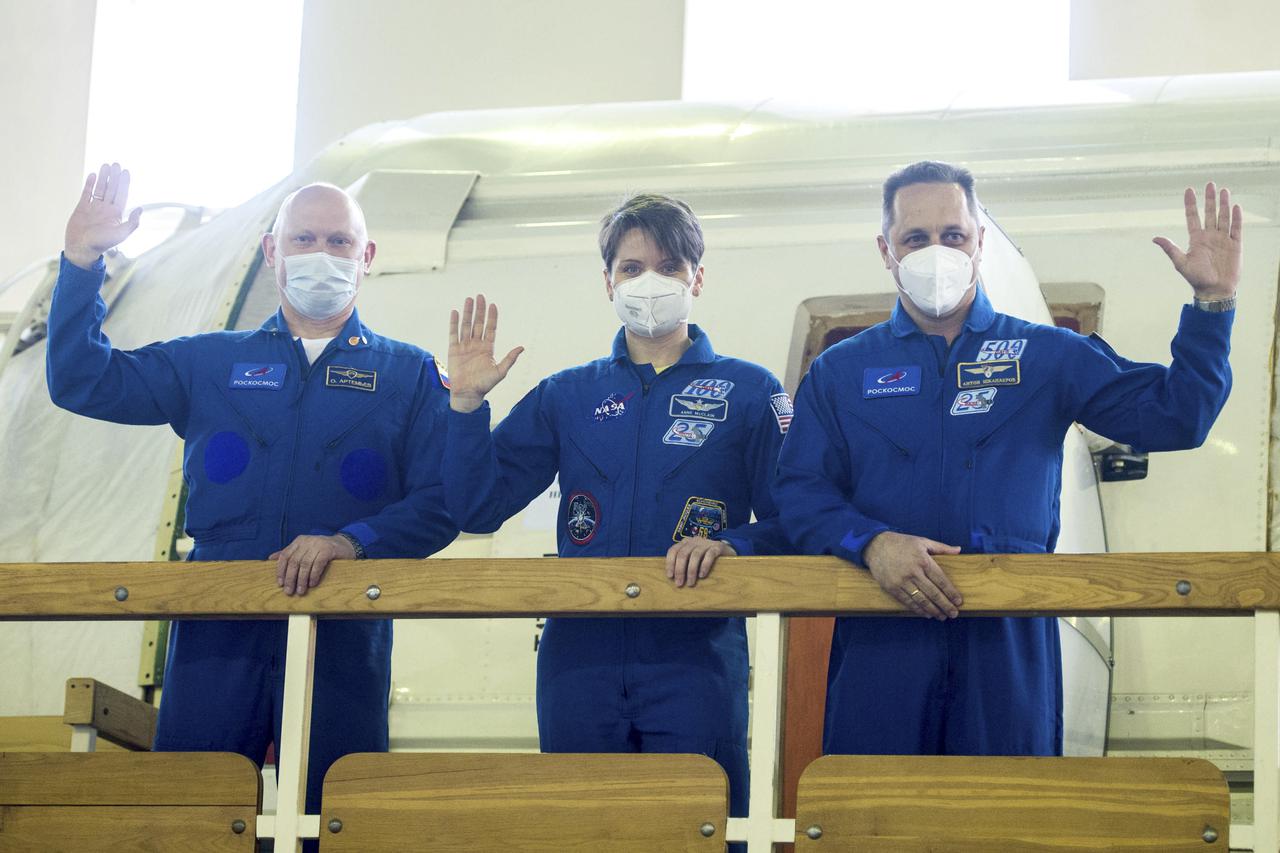 Expedition 65 backup crew members Russian cosmonaut Oleg Artemyev of Roscosmos, left, NASA astronaut Anne McClain, center, and Russian cosmonaut Anton Shkaplerov of Roscosmos, wave during Soyuz qualification exams Saturday, March 20, 2021 at the Gagarin Cosmonaut Training Center (GCTC) in Star City, Russia, in advance of the Expedition 65 launch April 9 from Baikonur Cosmodrome in Kazakhstan to the International Space Station. Photo Credit: (NASA/GCTC/Andrey Shelepin)