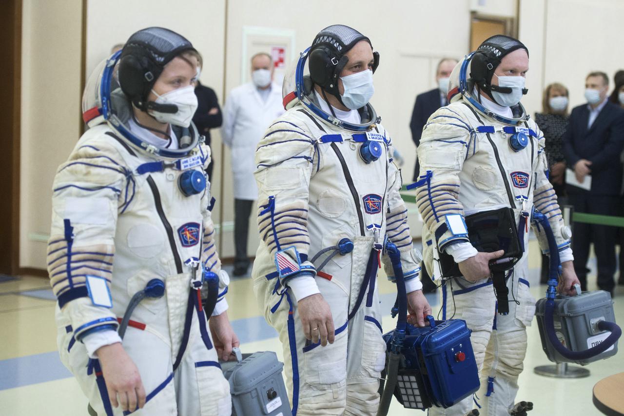 Expedition 65 backup crew members NASA astronaut Anne McClain, left, Russian cosmonaut Anton Shkaplerov of Roscosmos, center, and Russian cosmonaut Oleg Artemyev of Roscosmos arrive for Soyuz qualification exams Monday, March 22, 2021, at the Gagarin Cosmonaut Training Center (GCTC) in Star City, Russia, in advance of the Expedition 65 launch April 9 from Baikonur Cosmodrome in Kazakhstan to the International Space Station. Photo Credit: (NASA/GCTC/Andrey Shelepin)