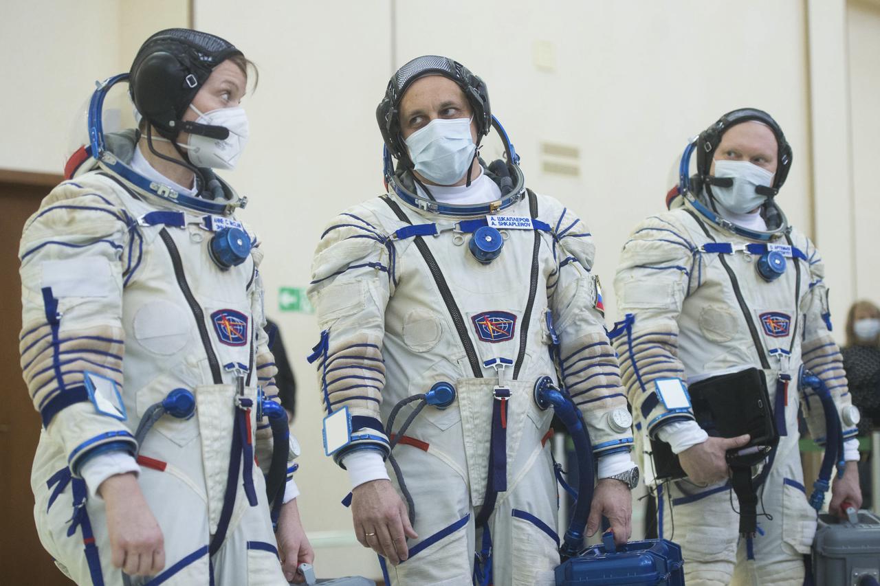 Expedition 65 backup crew members NASA astronaut Anne McClain, left, Russian cosmonaut Anton Shkaplerov of Roscosmos, center, and Russian cosmonaut Oleg Artemyev of Roscosmos arrive for Soyuz qualification exams Monday, March 22, 2021, at the Gagarin Cosmonaut Training Center (GCTC) in Star City, Russia, in advance of the Expedition 65 launch April 9 from Baikonur Cosmodrome in Kazakhstan to the International Space Station. Photo Credit: (NASA/GCTC/Andrey Shelepin)