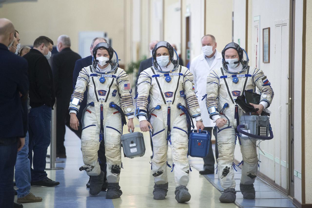 Expedition 65 backup crew members NASA astronaut Anne McClain, left, Russian cosmonaut Anton Shkaplerov of Roscosmos, center, and Russian cosmonaut Oleg Artemyev of Roscosmos arrive for Soyuz qualification exams Monday, March 22, 2021, at the Gagarin Cosmonaut Training Center (GCTC) in Star City, Russia, in advance of the Expedition 65 launch April 9 from Baikonur Cosmodrome in Kazakhstan to the International Space Station. Photo Credit: (NASA/GCTC/Andrey Shelepin)