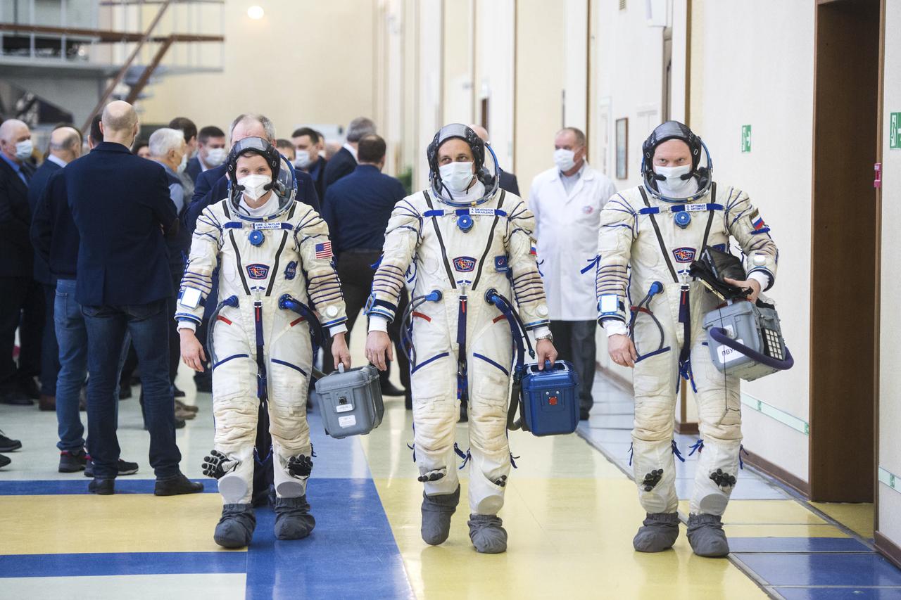 Expedition 65 backup crew members NASA astronaut Anne McClain, left, Russian cosmonaut Anton Shkaplerov of Roscosmos, center, and Russian cosmonaut Oleg Artemyev of Roscosmos arrive for Soyuz qualification exams Monday, March 22, 2021, at the Gagarin Cosmonaut Training Center (GCTC) in Star City, Russia, in advance of the Expedition 65 launch April 9 from Baikonur Cosmodrome in Kazakhstan to the International Space Station. Photo Credit: (NASA/GCTC/Andrey Shelepin)