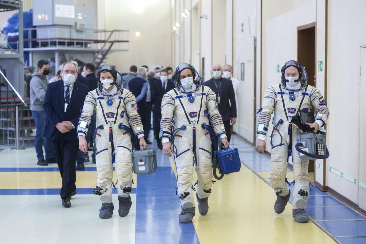 Expedition 65 backup crew members NASA astronaut Anne McClain, left, Russian cosmonaut Anton Shkaplerov of Roscosmos, center, and Russian cosmonaut Oleg Artemyev of Roscosmos arrive for Soyuz qualification exams Monday, March 22, 2021, at the Gagarin Cosmonaut Training Center (GCTC) in Star City, Russia, in advance of the Expedition 65 launch April 9 from Baikonur Cosmodrome in Kazakhstan to the International Space Station. Photo Credit: (NASA/GCTC/Andrey Shelepin)