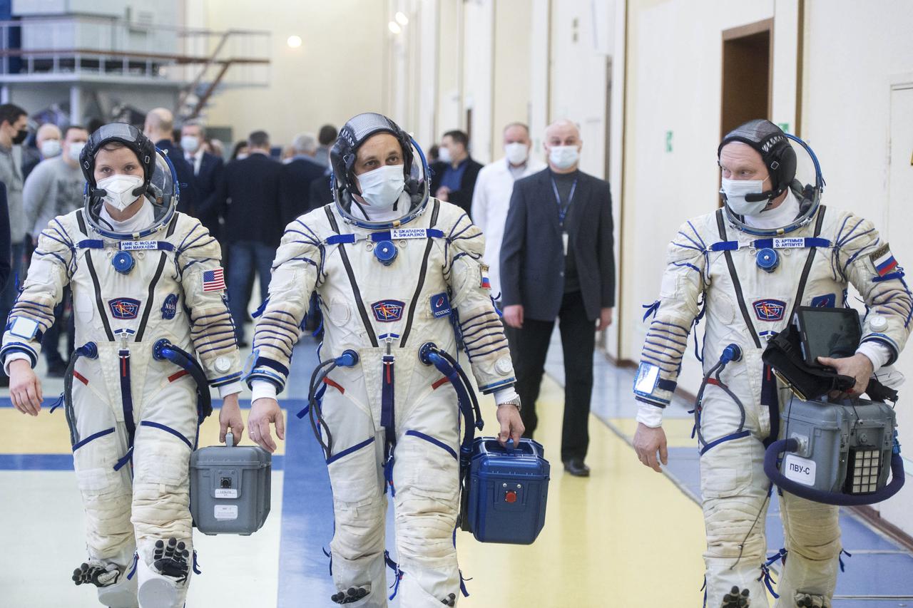 Expedition 65 backup crew members NASA astronaut Anne McClain, left, Russian cosmonaut Anton Shkaplerov of Roscosmos, center, and Russian cosmonaut Oleg Artemyev of Roscosmos arrive for Soyuz qualification exams Monday, March 22, 2021, at the Gagarin Cosmonaut Training Center (GCTC) in Star City, Russia, in advance of the Expedition 65 launch April 9 from Baikonur Cosmodrome in Kazakhstan to the International Space Station. Photo Credit: (NASA/GCTC/Andrey Shelepin)