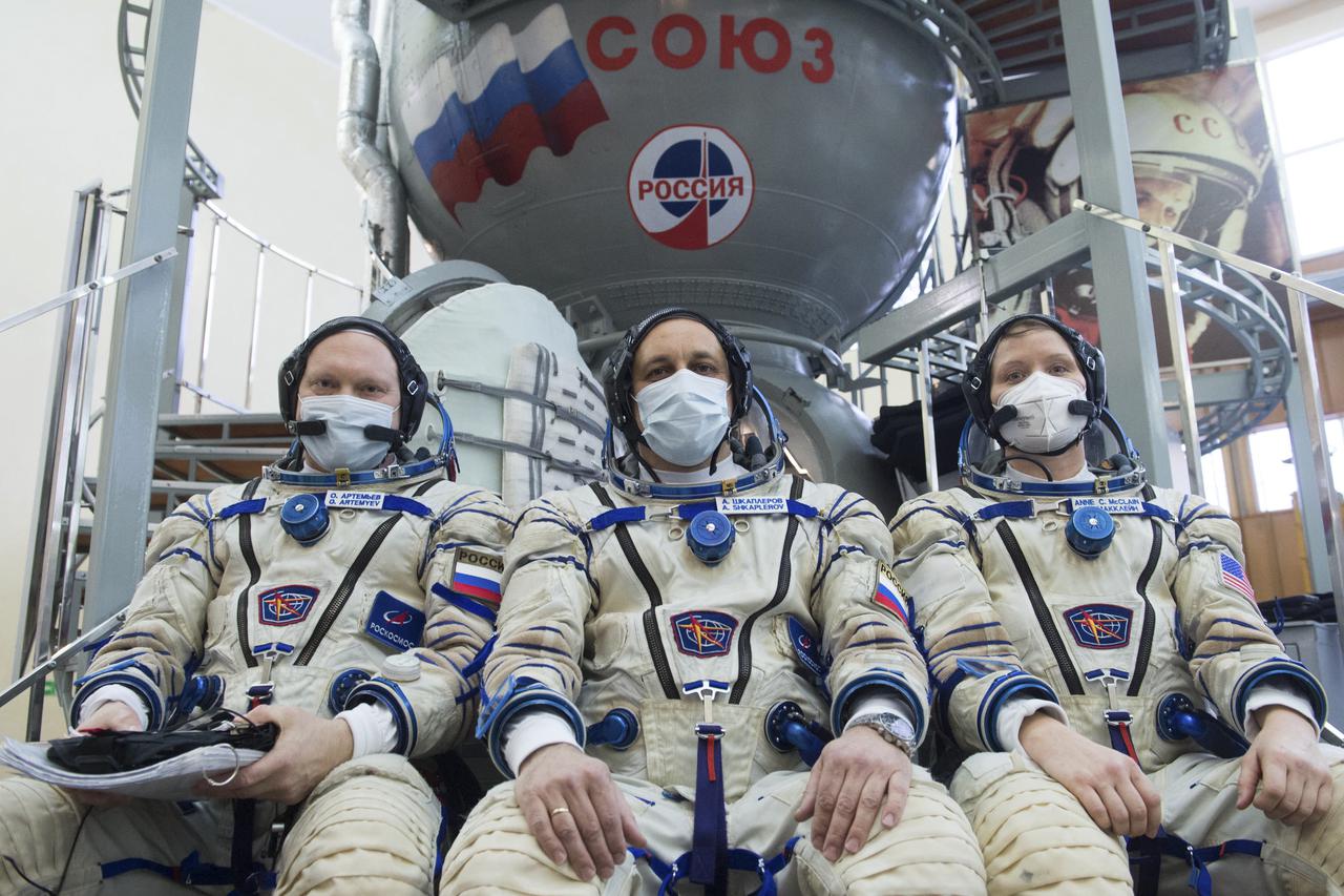 Expedition 65 backup crew members Russian cosmonaut Oleg Artemyev of Roscosmos, left, Russian cosmonaut Anton Shkaplerov of Roscosmos, center, and NASA astronaut Anne McClain, pose for a photo during Soyuz qualification exams Monday, March 22, 2021, at the Gagarin Cosmonaut Training Center (GCTC) in Star City, Russia, in advance of the Expedition 65 launch April 9 from Baikonur Cosmodrome in Kazakhstan to the International Space Station. Photo Credit: (NASA/GCTC/Andrey Shelepin)