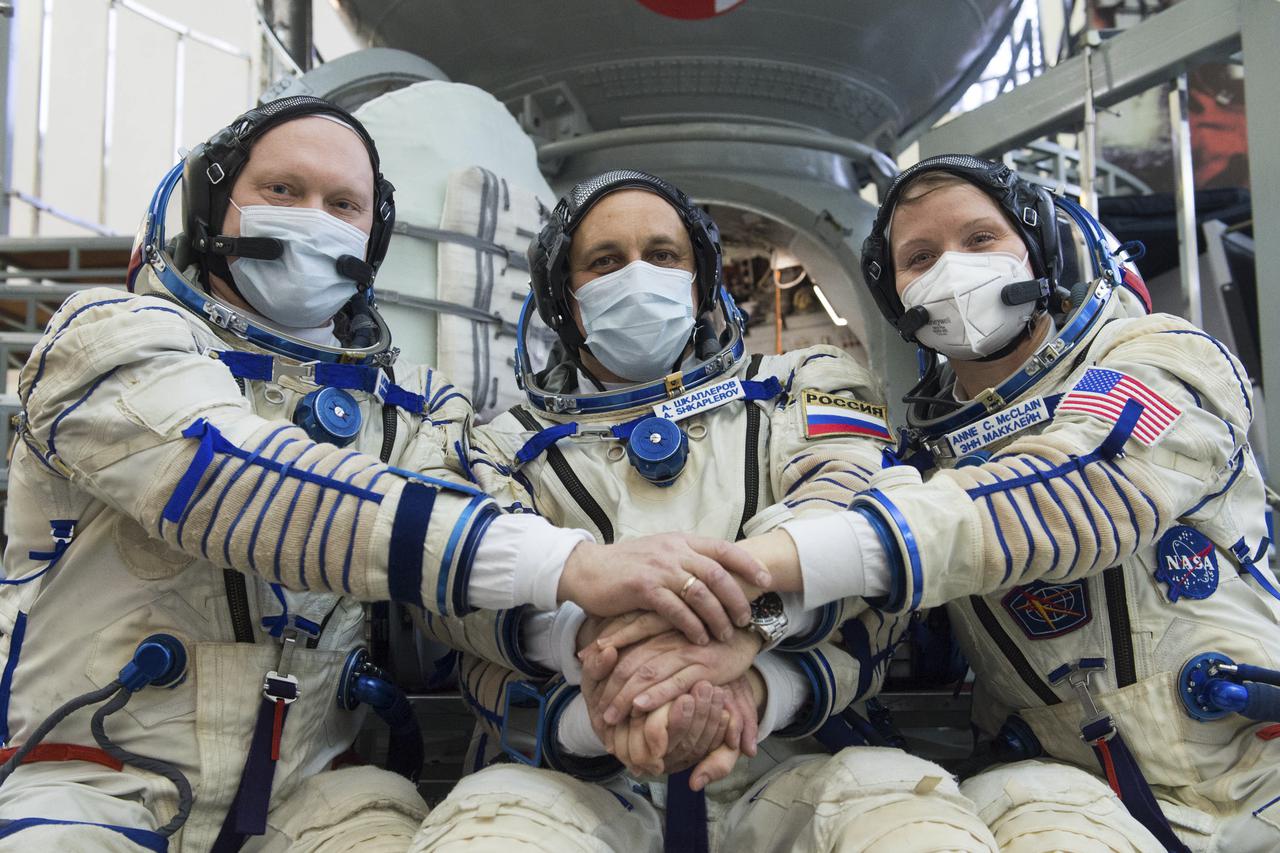 Expedition 65 backup crew members Russian cosmonaut Oleg Artemyev of Roscosmos, left, Russian cosmonaut Anton Shkaplerov of Roscosmos, center, and NASA astronaut Anne McClain, pose for a photo during Soyuz qualification exams Monday, March 22, 2021, at the Gagarin Cosmonaut Training Center (GCTC) in Star City, Russia, in advance of the Expedition 65 launch April 9 from Baikonur Cosmodrome in Kazakhstan to the International Space Station. Photo Credit: (NASA/GCTC/Andrey Shelepin)
