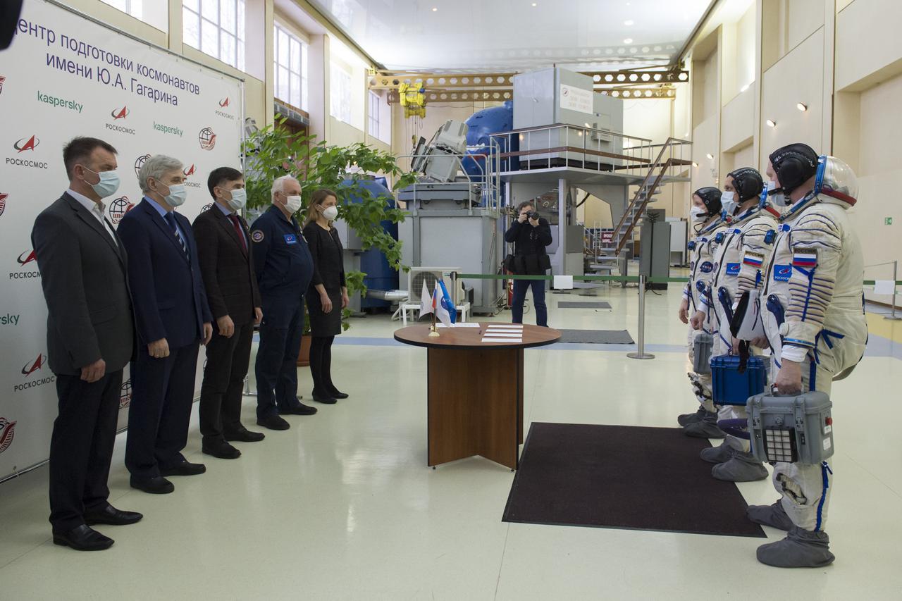Expedition 65 backup crew members NASA astronaut Anne McClain, left, Russian cosmonaut Anton Shkaplerov of Roscosmos, center, and Russian cosmonaut Oleg Artemyev of Roscosmos meet with mission managers during Soyuz qualification exams Monday, March 22, 2021 at the Gagarin Cosmonaut Training Center (GCTC) in Star City, Russia, in advance of the Expedition 65 launch April 9 from Baikonur Cosmodrome in Kazakhstan to the International Space Station. Photo Credit: (NASA/GCTC/Irina Spector)