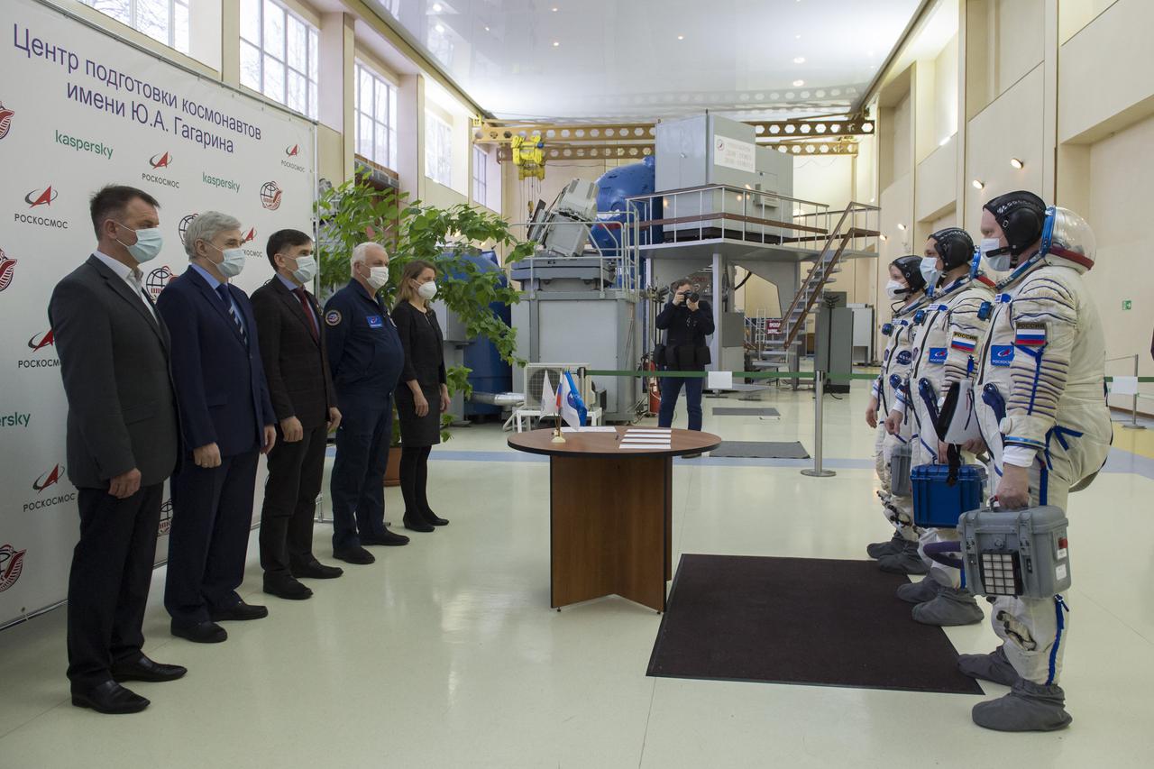 Expedition 65 backup crew members NASA astronaut Anne McClain, left, Russian cosmonaut Anton Shkaplerov of Roscosmos, center, and Russian cosmonaut Oleg Artemyev of Roscosmos meet with mission managers during Soyuz qualification exams Monday, March 22, 2021 at the Gagarin Cosmonaut Training Center (GCTC) in Star City, Russia, in advance of the Expedition 65 launch April 9 from Baikonur Cosmodrome in Kazakhstan to the International Space Station. Photo Credit: (NASA/GCTC/Irina Spector)