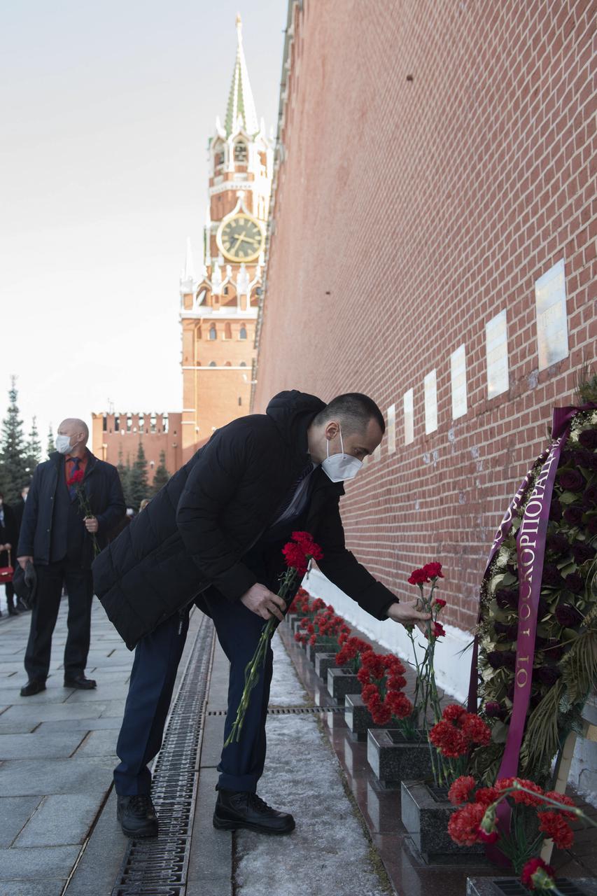 Expedition 65 prime crew member Russian cosmonaut Pyotr Dubrov of Roscosmos lays flowers at the site where Russian space icons are interred as part of traditional pre-launch ceremonies, Wednesday, March 24, 2021, at Red Square in Moscow. Photo Credit: (NASA/GCTC/Andrey Shelepin)
