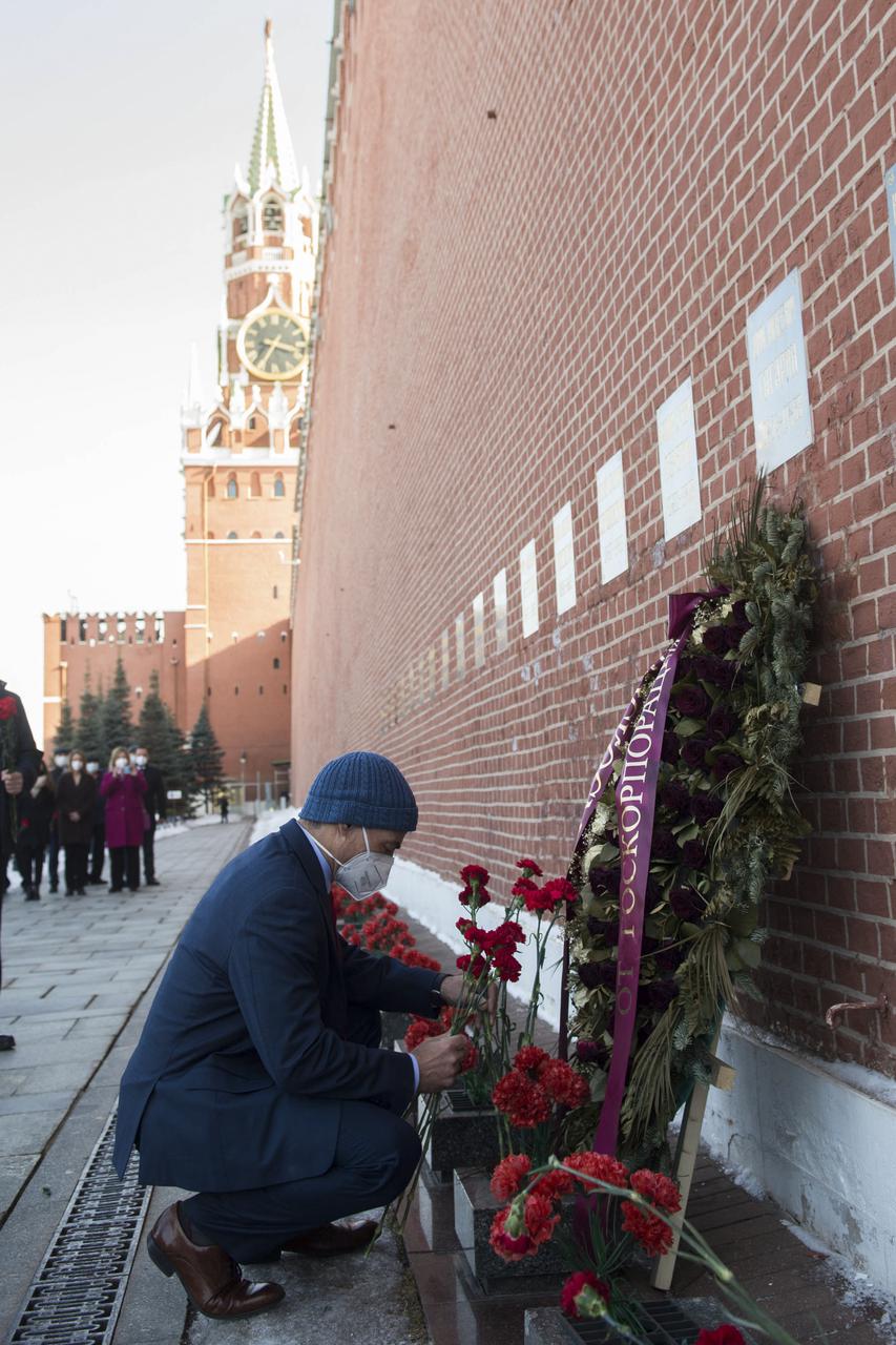 Expedition 65 prime crew member NASA astronaut Mark Vande Hei lays flowers at the site where Russian space icons are interred as part of traditional pre-launch ceremonies, Wednesday, March 24, 2021, at Red Square in Moscow. Photo Credit: (NASA/GCTC/Andrey Shelepin)