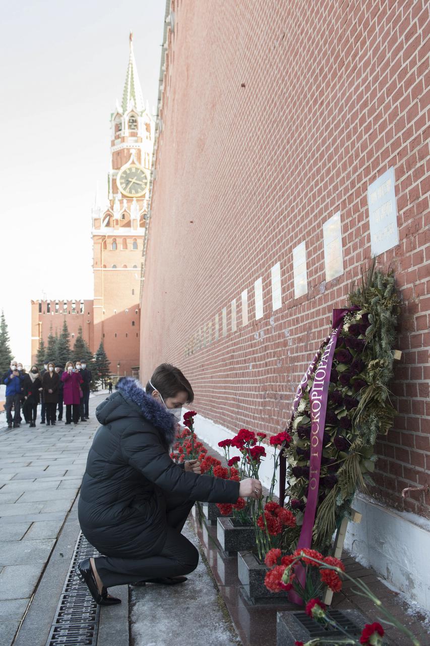 Expedition 65 backup crew member NASA astronaut Anne McClain lays flowers at the site where Russian space icons are interred as part of traditional pre-launch ceremonies, Wednesday, March 24, 2021, at Red Square in Moscow. Photo Credit: (NASA/GCTC/Andrey Shelepin)