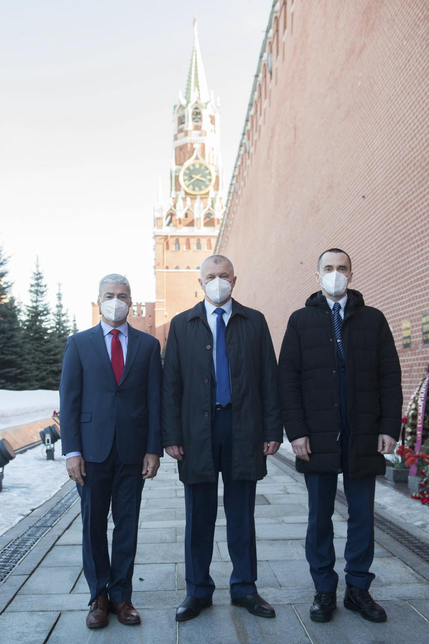 Expedition 65 prime crew members, NASA astronaut Mark Vande Hei, left, Russian cosmonaut Oleg Novitskiy of Roscosmos, center, and Russian cosmonaut Pyotr Dubrov of Roscosmos, right, pose for a photo in Red Square after laying flowers at the site where Russian space icons are interred as part of traditional pre-launch ceremonies, Wednesday, March 24, 2021 in Moscow. Photo Credit: (NASA/GCTC/Andrey Shelepin)