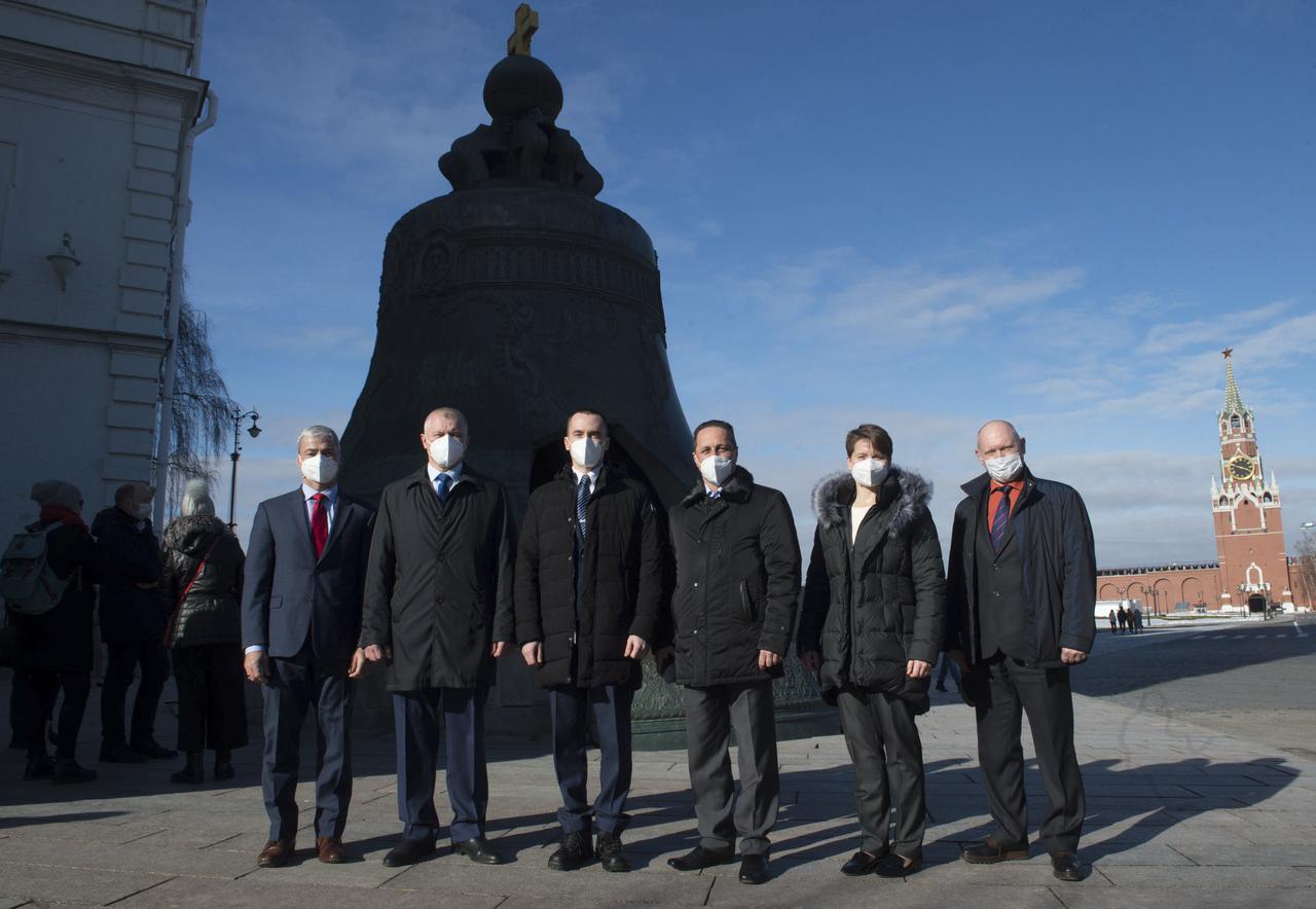 Expedition 65 prime crew members, NASA astronaut Mark Vande Hei, left, Russian cosmonaut Oleg Novitskiy of Roscosmos, second form left, and Russian cosmonaut Pyotr Dubrov of Roscosmos, third from left, and backup crew members Russian cosmonaut Anton Shkaplerov of Roscosmos, third from right, NASA astronaut Anne McClain, second from right, and Russian cosmonaut Oleg Artemyev of Roscosmos, right, pose for a photo in front of the Tsar Bell in Red Square after laying flowers at the site where Russian space icons are interred as part of traditional pre-launch ceremonies, Wednesday, March 24, 2021 in Moscow. Photo Credit: (NASA/GCTC/Andrey Shelepin)