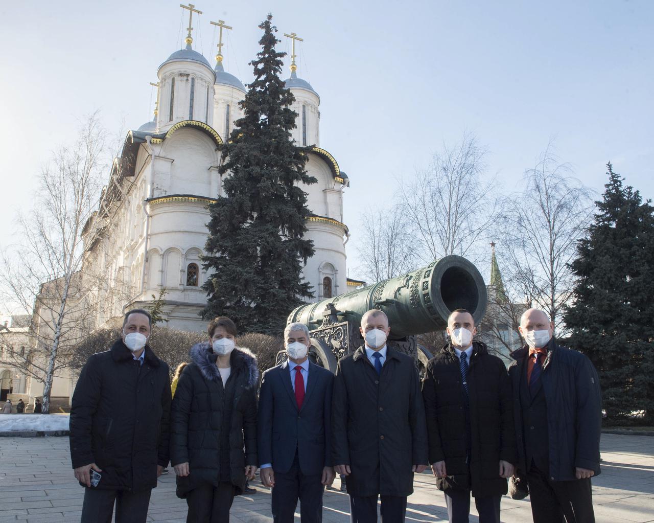 Expedition 65 backup crew members Russian cosmonaut Anton Shkaplerov, left, NASA astronaut Anne McClain, second from left, prime crew members NASA astronaut Mark Vande Hei, third from left, Russian cosmonaut Oleg Novitskiy of Roscosmos, third from right, and Russian cosmonaut Pyotr Dubrov of Roscosmos, second from right, and backup crew member Russian cosmonaut Oleg Artemyev of Roscosmos, right, pose for a photo in front of the Tsar Cannon in Red Square after laying flowers at the site where Russian space icons are interred as part of traditional pre-launch ceremonies, Wednesday, March 24, 2021 in Moscow. Photo Credit: (NASA/GCTC/Andrey Shelepin)