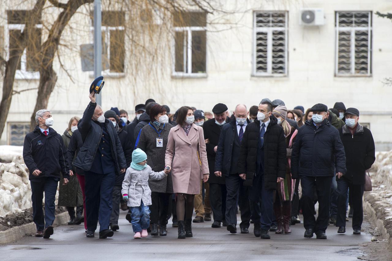 Expedition 65 prime crew members, NASA astronaut Mark Vande Hei, left, Russian cosmonaut Oleg Novitskiy of Roscosmos, second from left, and Russian cosmonaut Pyotr Dubrov of Roscosmos, second from right, are seen walking with friends and family during an official farewell ceremony prior to their departure to Baikonur for launch from the Baikonur Cosmodrome, Friday, March 26, 2021 at the Gagarin Cosmonaut Training Center (GCTC) in Star City, Russia. Photo Credit: (NASA/GCTC/Andrey Shelepin)