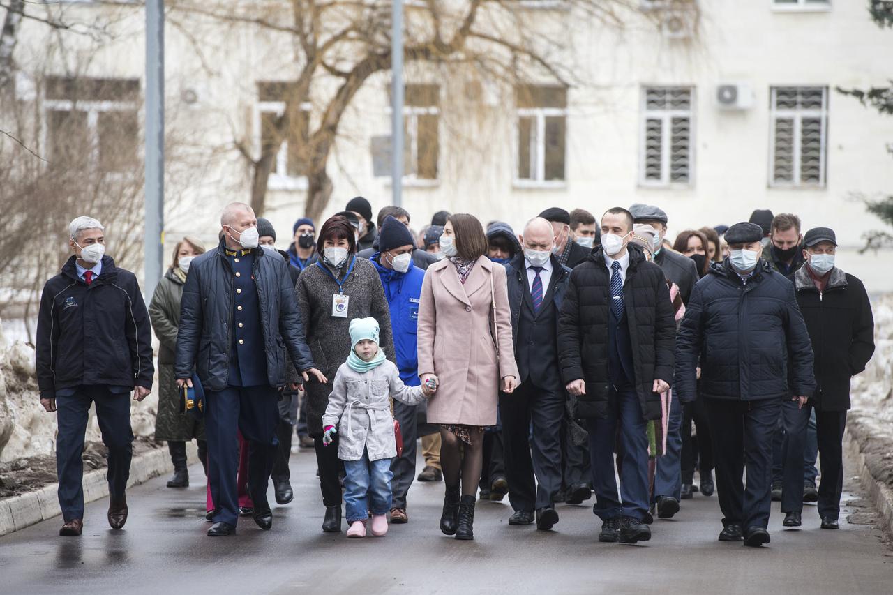 Expedition 65 prime crew members, NASA astronaut Mark Vande Hei, left, Russian cosmonaut Oleg Novitskiy of Roscosmos, second from left, and Russian cosmonaut Pyotr Dubrov of Roscosmos, second from right, are seen walking with friends and family during an official farewell ceremony prior to their departure to Baikonur for launch from the Baikonur Cosmodrome, Friday, March 26, 2021 at the Gagarin Cosmonaut Training Center (GCTC) in Star City, Russia. Photo Credit: (NASA/GCTC/Andrey Shelepin)