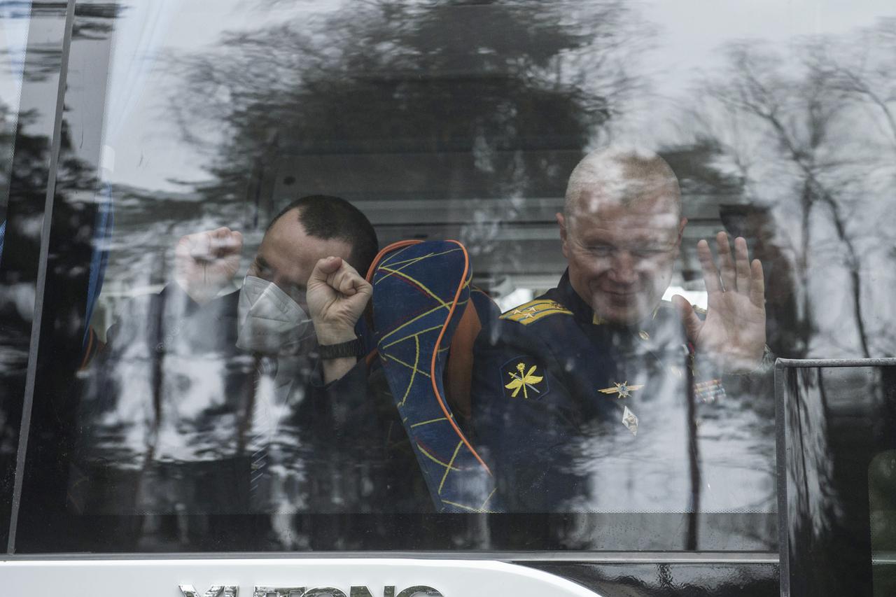 Expedition 65 prime crew members, Russian cosmonauts Pyotr Dubrov of Roscosmos, left, and Oleg Novitskiy of Roscosmos, wave goodbye after boarding the bus to their flight to Baikonur for launch from the Baikonur Cosmodrome, Friday, March 26, 2021 at the Gagarin Cosmonaut Training Center (GCTC) in Star City, Russia. Photo Credit: (NASA/GCTC/Andrey Shelepin)