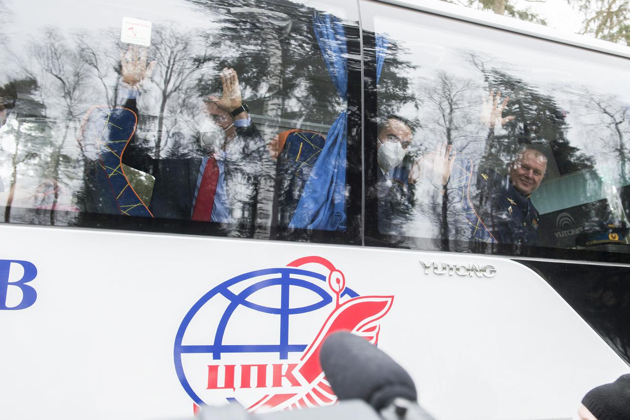 From left to right, Expedition 65 prime crew members, NASA astronaut Mark Vande Hei, Russian cosmonaut Pyotr Dubrov of Roscosmos, and Russian cosmonaut Oleg Novitskiy of Roscosmos, wave goodbye after boarding the bus to their flight to Baikonur for launch from the Baikonur Cosmodrome, Friday, March 26, 2021 at the Gagarin Cosmonaut Training Center (GCTC) in Star City, Russia. Photo Credit: (NASA/GCTC/Andrey Shelepin)