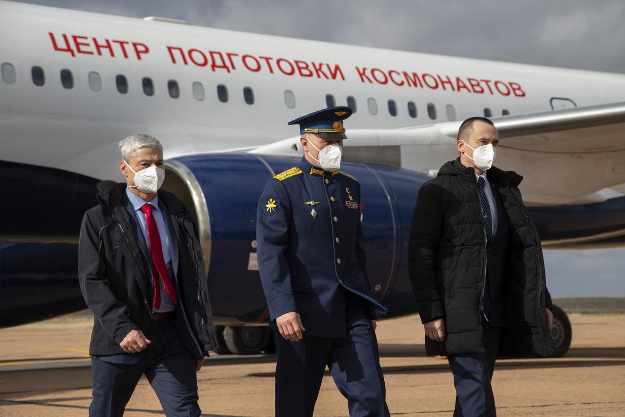Expedition 65 prime crew members, NASA astronaut Mark Vande Hei, left, and Russian cosmonauts Oleg Novitskiy of Roscosmos, center, and Pyotr Dubrov of Roscosmos, right, arrive in Baikonur, Kazakhstan from the Gagarin Cosmonaut Training Center (GCTC), Friday, March 26, 2021. They are scheduled to launch from the Baikonur Cosmodrome on a Soyuz rocket April 9. Photo Credit: (NASA/GCTC/Irina Spector)
