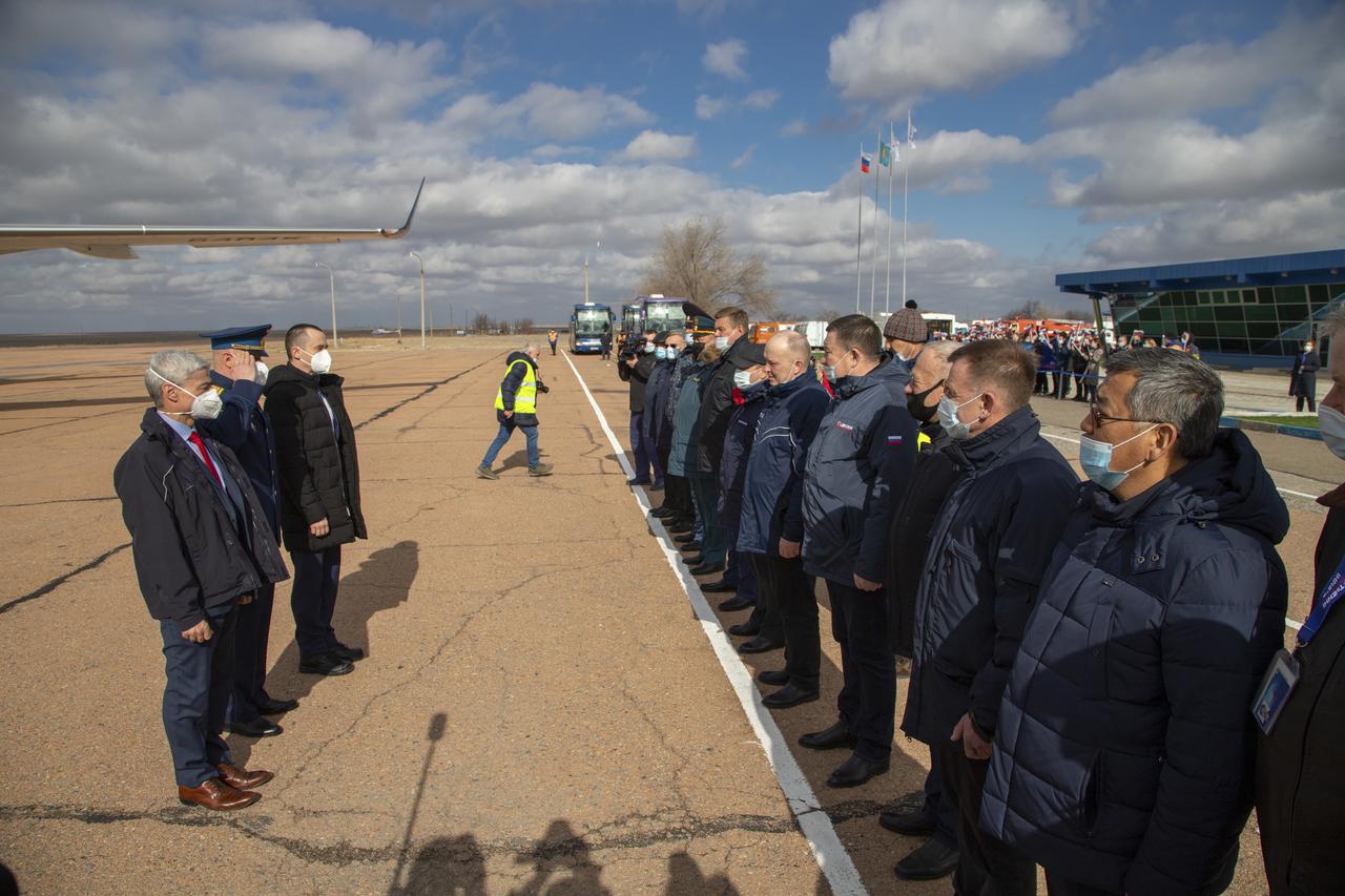 Expedition 65 prime crew members, NASA astronaut Mark Vande Hei, left, and Russian cosmonauts Oleg Novitskiy of Roscosmos, center, and Pyotr Dubrov of Roscosmos, right, meet with mission managers after arriving in Baikonur, Kazakhstan from the Gagarin Cosmonaut Training Center (GCTC), Friday, March 26, 2021. They are scheduled to launch from the Baikonur Cosmodrome on a Soyuz rocket April 9. Photo Credit: (NASA/GCTC/Irina Spector)