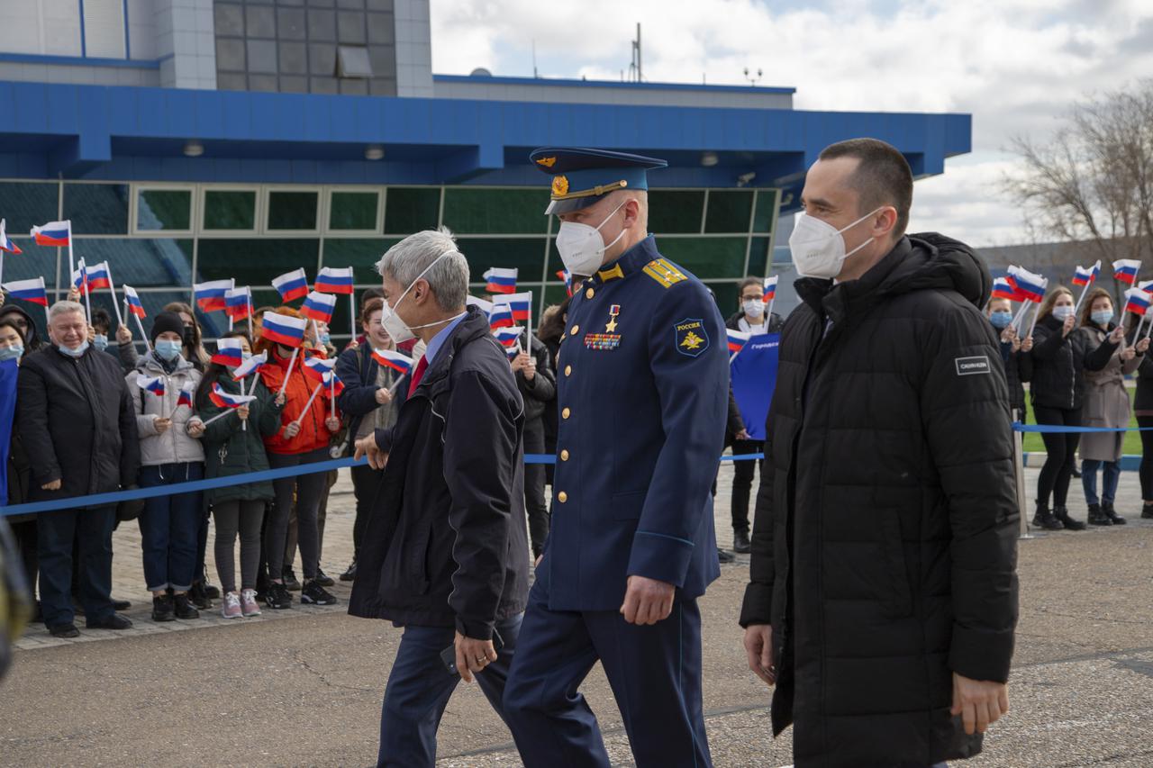 Expedition 65 prime crew members, NASA astronaut Mark Vande Hei, left, and Russian cosmonauts Oleg Novitskiy of Roscosmos, center, and Pyotr Dubrov of Roscosmos, right are greeted by onlookers after arriving in Baikonur, Kazakhstan from the Gagarin Cosmonaut Training Center (GCTC), Friday, March 26, 2021. They are scheduled to launch from the Baikonur Cosmodrome on a Soyuz rocket April 9. Photo Credit: (NASA/GCTC/Irina Spector)