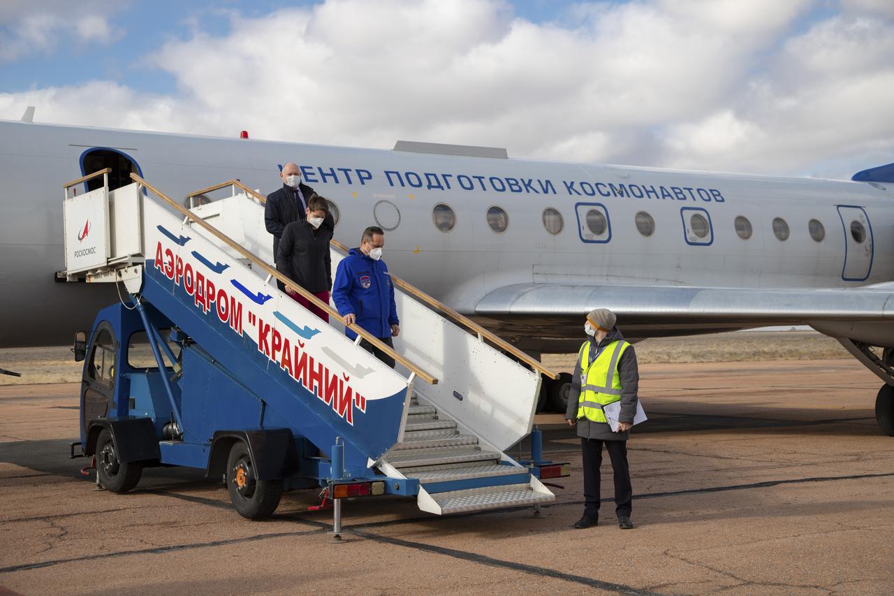 Expedition 65 backup crew members Russian cosmonaut Anton Shkaplerov of Roscosmos, first, NASA astronaut Anne McClain, second, and Oleg Artemyev of Roscosmos, arrive in Baikonur, Kazakhstan from the Gagarin Cosmonaut Training Center (GCTC), Friday, March 26, 2021. The prime crew is scheduled to launch from the Baikonur Cosmodrome on a Soyuz rocket April 9. Photo Credit: (NASA/GCTC/Irina Spector)