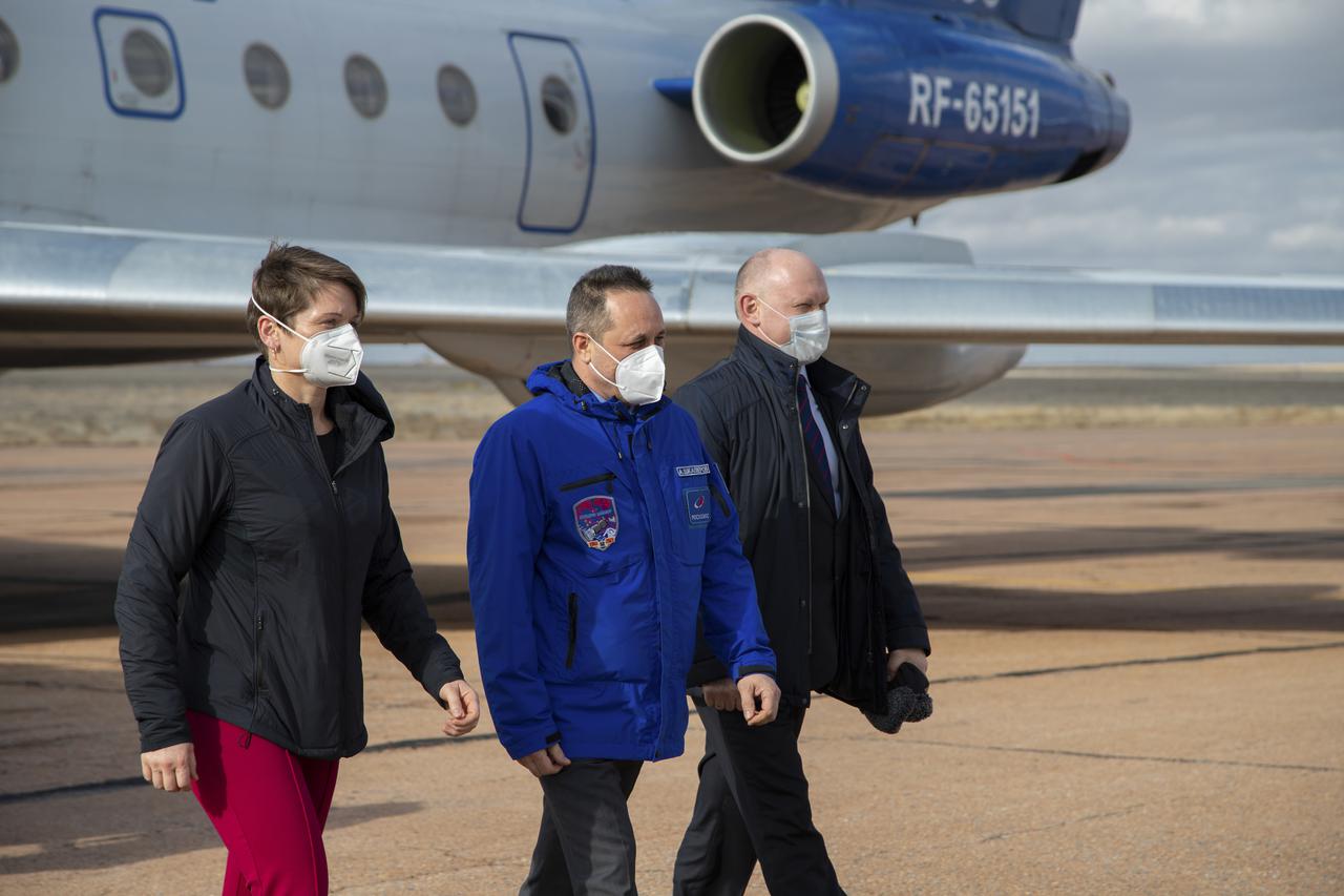 Expedition 65 backup crew members NASA astronaut Anne McClain, left, and Russian cosmonauts Anton Shkaplerov of Roscosmos, center, and Oleg Artemyev of Roscosmos, right, arrive in Baikonur, Kazakhstan from the Gagarin Cosmonaut Training Center (GCTC), Friday, March 26, 2021. The prime crew is scheduled to launch from the Baikonur Cosmodrome on a Soyuz rocket April 9. Photo Credit: (NASA/GCTC/Irina Spector)