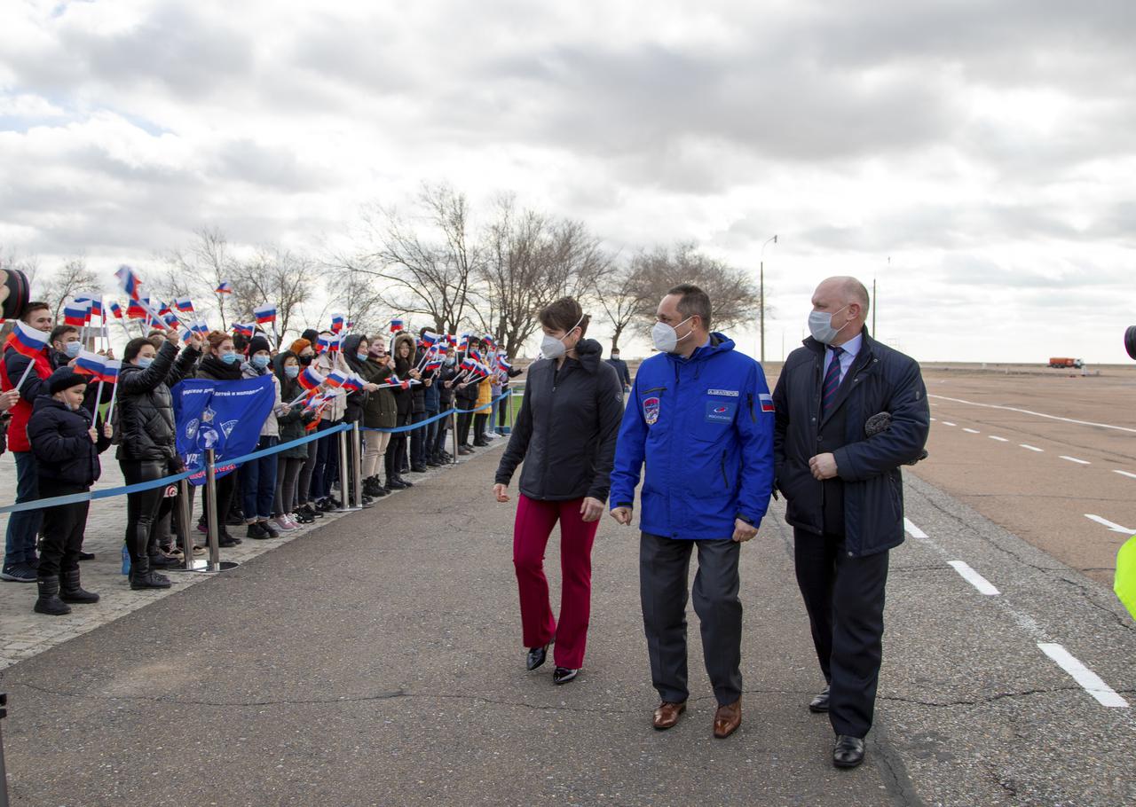 Expedition 65 backup crew members NASA astronaut Anne McClain, left, and Russian cosmonauts Anton Shkaplerov of Roscosmos, center, and Oleg Artemyev of Roscosmos, right, are greeted by onlookers after arriving in Baikonur, Kazakhstan from the Gagarin Cosmonaut Training Center (GCTC), Friday, March 26, 2021. The prime crew is scheduled to launch from the Baikonur Cosmodrome on a Soyuz rocket April 9. Photo Credit: (NASA/GCTC/Irina Spector)