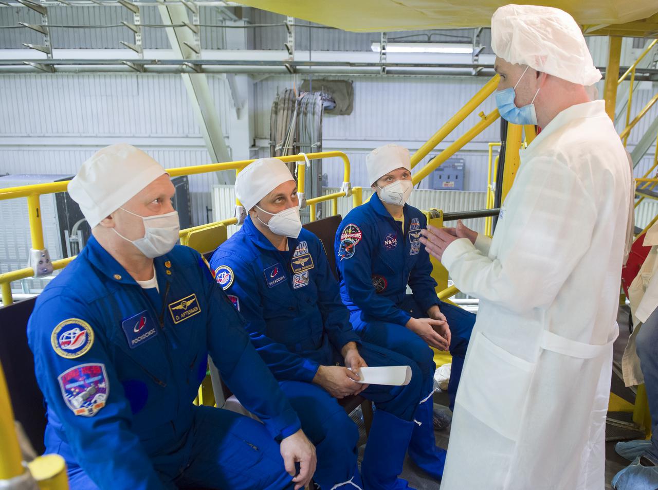 Expedition 65 backup crew members Russian cosmonauts Oleg Artemyev of Roscosmos, left, Anton Shkaplerov of Roscosmos, center, and NASA astronaut Anne McClain, are seen during a fit check Saturday, March 27, 2021 at the Baikonur Cosmodrome in Kazakhstan. The prime crew is scheduled to launch on a Soyuz rocket April 9. Photo Credit: (NASA/GCTC/Irina Spector)