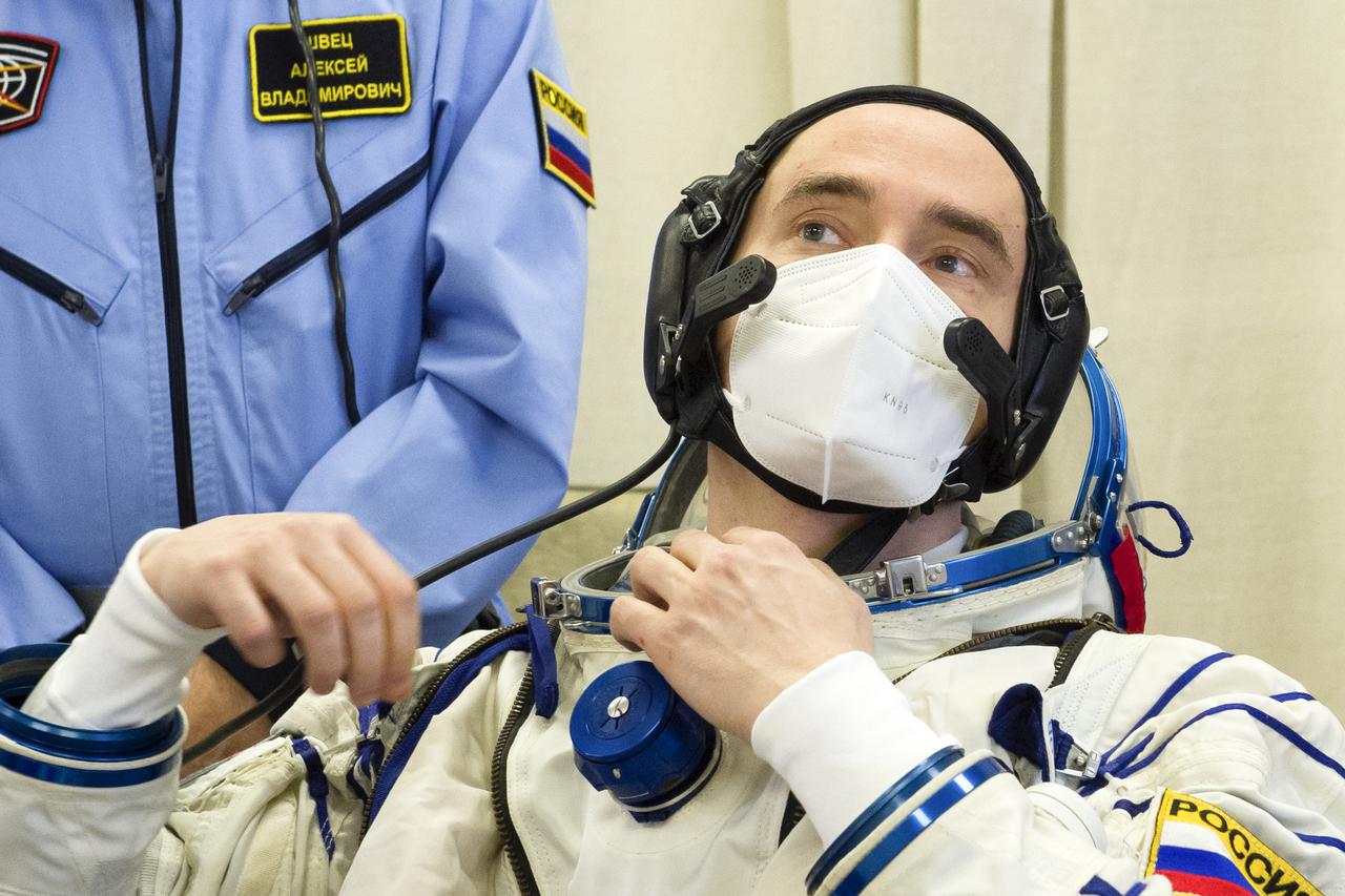 Expedition 65 prime crew member Pyotr Dubrov of Roscosmos dons his Sokol suit during the fit check to prepare for launch with fellow Russian cosmonaut Oleg Novitskiy of Roscosmos, and NASA astronaut Mark Vande Hei, Saturday, March 27, 2021 at the Baikonur Cosmodrome in Kazakhstan. They are scheduled to launch on a Soyuz rocket April 9. Photo Credit: (NASA/GCTC/Irina Spector)