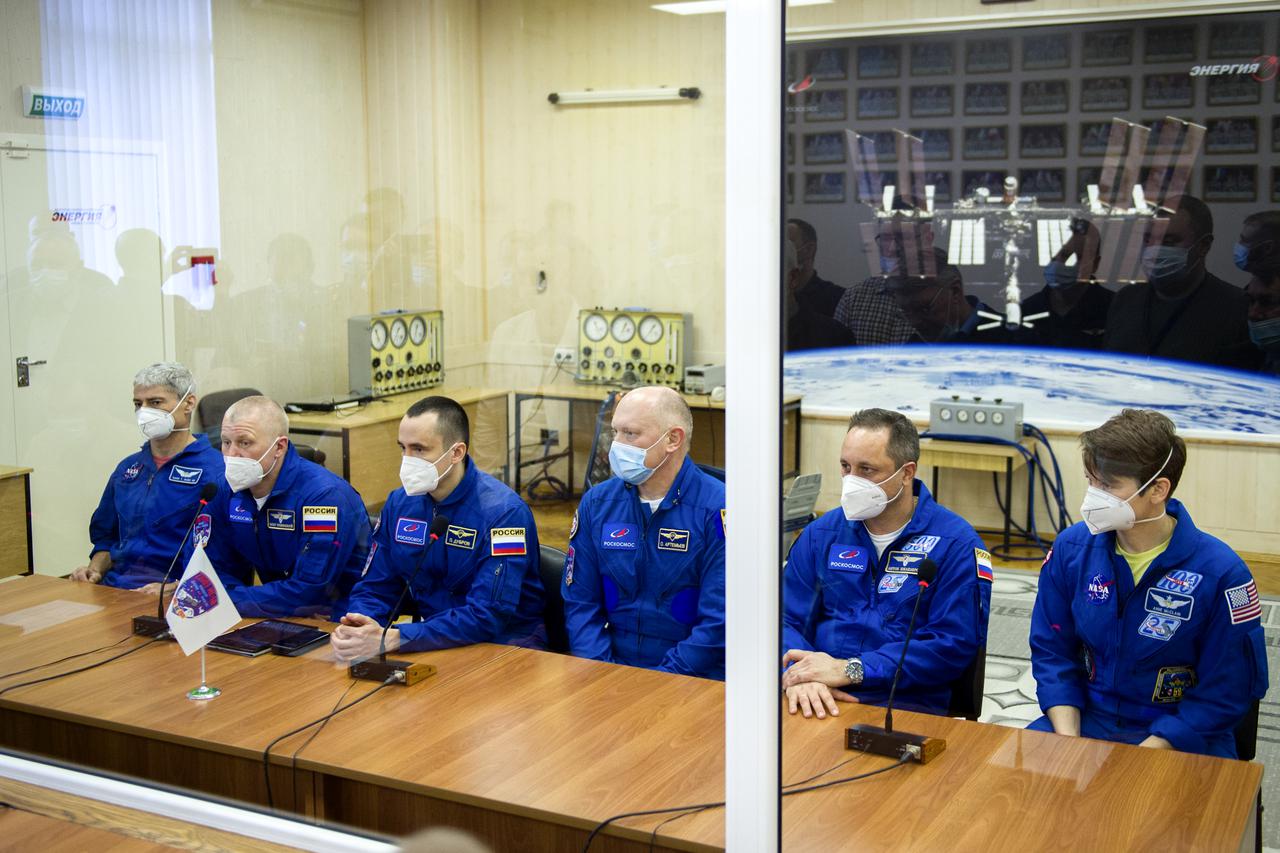 From left to right, Expedition 65 prime crew members NASA astronaut Mark Vande Hei, Russian cosmonauts Oleg Novitskiy of Roscosmos, and Pyotr Dubrov of Roscosmos are seen behind glass for quarantine with Expedition 65 backup crew members Russian cosmonauts Oleg Artemyev of Roscosmos, Anton Shkaplerov, and NASA astronaut Anne McClain, after a fit check in preparation for launch of the prime crew, Saturday, March 27, 2021 at the Baikonur Cosmodrome in Kazakhstan. They are scheduled to launch on a Soyuz rocket April 9. Photo Credit: (NASA/GCTC/Irina Spector)