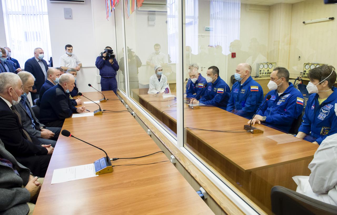 From left to right, Expedition 65 prime crew members NASA astronaut Mark Vande Hei, Russian cosmonauts Oleg Novitskiy of Roscosmos, and Pyotr Dubrov of Roscosmos meet with mission managers from behind glass for quarantine with Expedition 65 backup crew members Russian cosmonauts Oleg Artemyev of Roscosmos, Anton Shkaplerov, and NASA astronaut Anne McClain, in preparation for launch of the prime crew, Saturday, March 27, 2021 at the Baikonur Cosmodrome in Kazakhstan. They are scheduled to launch on a Soyuz rocket April 9. Photo Credit: (NASA/GCTC/Irina Spector)