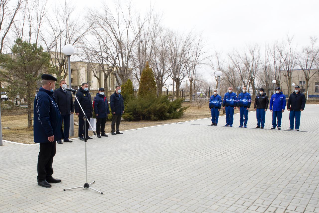 Expedition 65 prime and backup crew members rare seen just after raising the flags of Russia, the United States, and Kazakhstan, Sunday, March 28, 2021, in traditional ceremonies outside the Cosmonaut Hotel in Baikonur, Kazakhstan. From left to right, Expedition 65 prime crew members, NASA astronaut Mark Vande Hei, Russian cosmonauts Oleg Novitskiy of Roscosmos and Pyotr Dubrov of Roscosmos, and Expedition 65 backup crew members NASA astronaut Anne McClain, and Russian cosmonauts Anton Shkaplerov of Roscosmos, and Oleg Artemyev of Roscosmos. The prime crew is scheduled to launch to the International Space Station on a Soyuz rocket April 9. Photo Credit: (NASA/GCTC/Irina Spector)