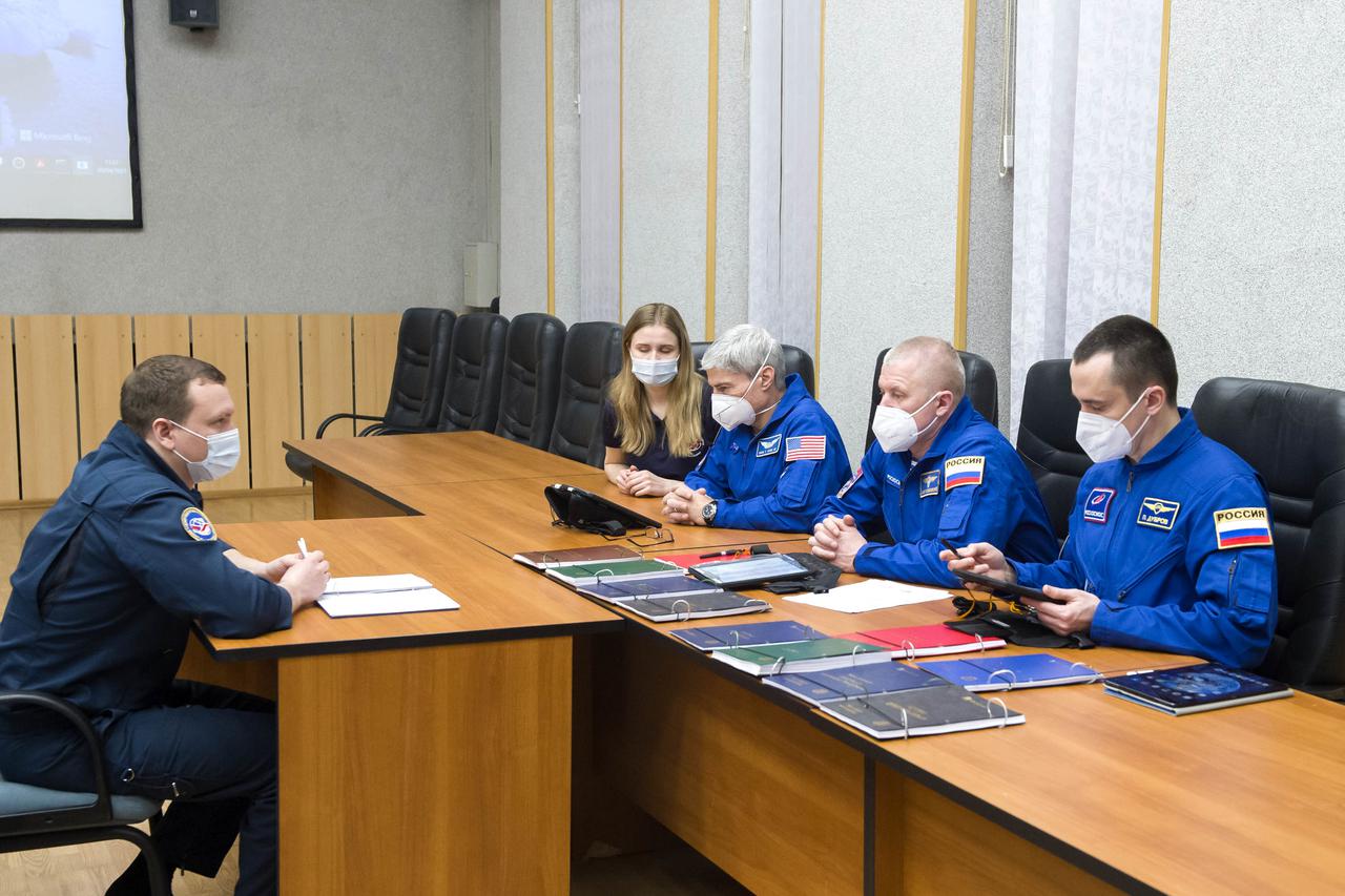 Expedition 65 prime crew members NASA astronaut Mark Vande Hei, second from left, and Russian cosmonauts Oleg Novitskiy, center, and Pyotr Dubrov, right, of Roscosmos review launch procedures with trainers, Saturday, April 3, 2021, in Baikonur, Kazakhstan. They are scheduled to launch to the International Space Station aboard the Soyuz MS-18 spacecraft on April 9. Photo Credit: (NASA/GCTC/Irina Spector)