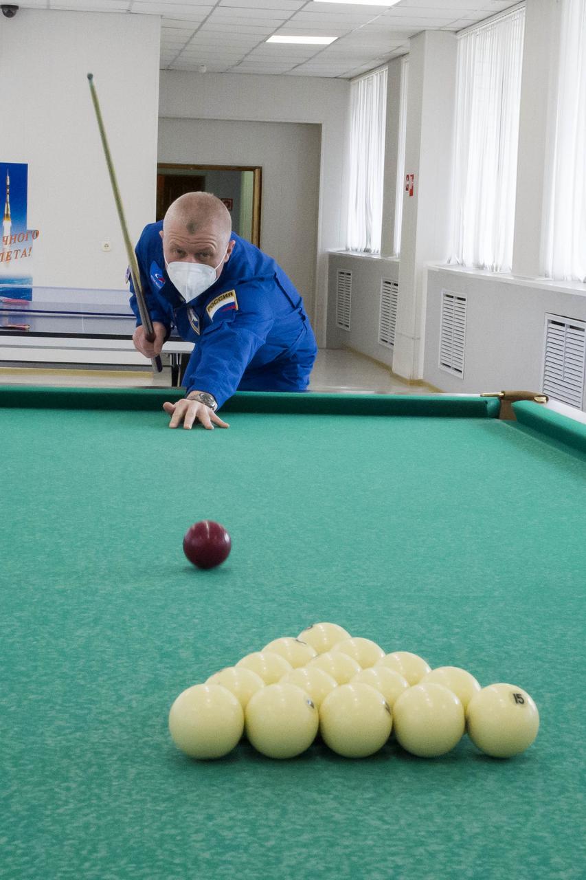 Expedition 65 prime crew member Russian cosmonaut Oleg Novitskiy of Roscosmos plays a game of billiards, Saturday, April 3, 2021, at the Cosmonaut Hotel in Baikonur, Kazakhstan. The prime crew, Novitskiy, NASA astronaut Mark Vande Hei, and Russian cosmonaut Pyotr Dubrov of Roscosmos are scheduled to launch to the International Space Station aboard the Soyuz MS-18 spacecraft on April 9. Photo Credit: (NASA/GCTC/Irina Spector)