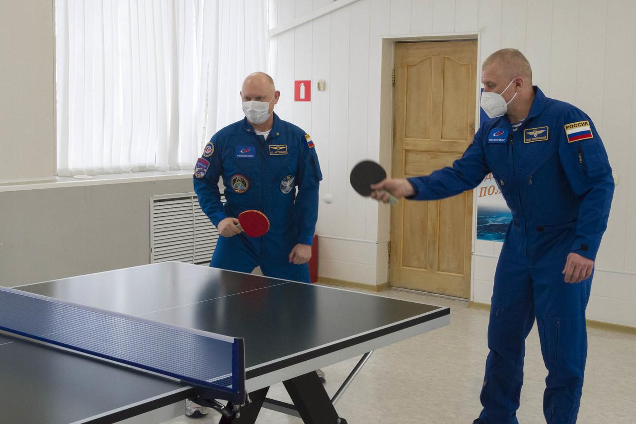 Expedition 65 backup crew member Russian cosmonaut Oleg Artemyev of Roscosmos, left, and Expedition 65 prime crew member Russian cosmonaut Oleg Novitskiy of Roscosmos play a game of ping-pong, Saturday, April 3, 2021, at the Cosmonaut Hotel in Baikonur, Kazakhstan. The prime crew, Novitskiy, NASA astronaut Mark Vande Hei, and Russian cosmonaut Pyotr Dubrov of Roscosmos are scheduled to launch to the International Space Station aboard the Soyuz MS-18 spacecraft on April 9. Photo Credit: (NASA/GCTC/Irina Spector)