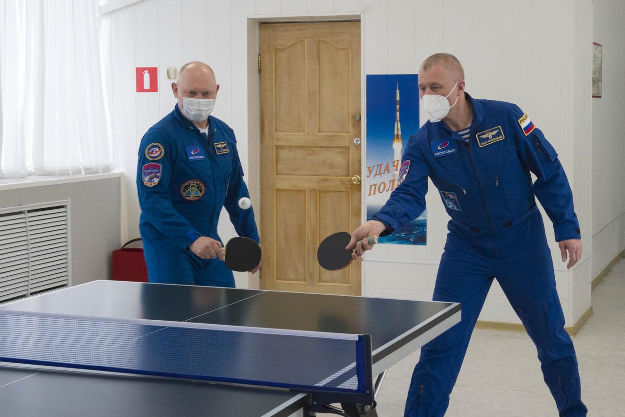 Expedition 65 backup crew member Russian cosmonaut Oleg Artemyev of Roscosmos, left, and Expedition 65 prime crew member Russian cosmonaut Oleg Novitskiy of Roscosmos play a game of ping-pong, Saturday, April 3, 2021, at the Cosmonaut Hotel in Baikonur, Kazakhstan. The prime crew, Novitskiy, NASA astronaut Mark Vande Hei, and Russian cosmonaut Pyotr Dubrov of Roscosmos are scheduled to launch to the International Space Station aboard the Soyuz MS-18 spacecraft on April 9. Photo Credit: (NASA/GCTC/Irina Spector)