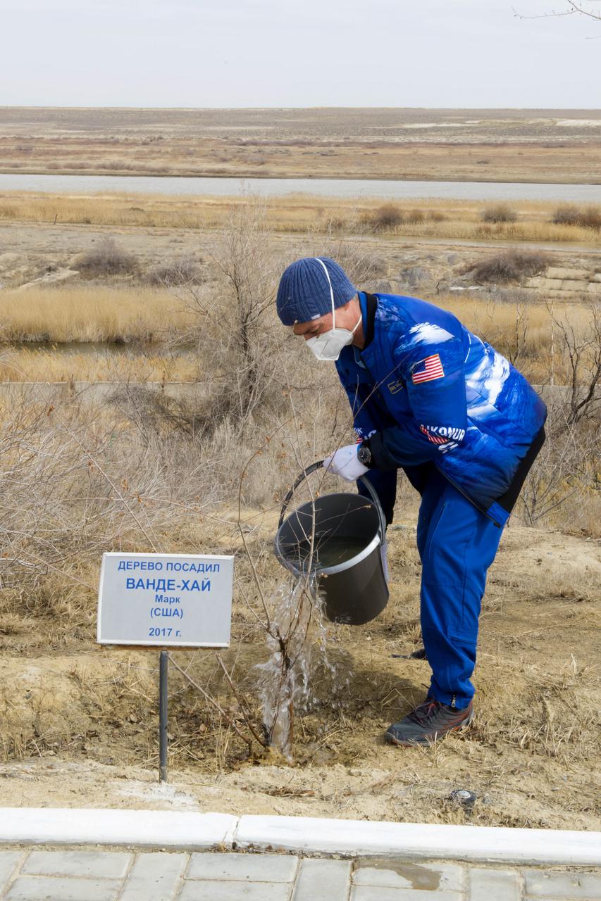Expedition 65 prime crew member NASA astronaut Mark Vande Hei, waters a tree bearing his name as part of traditional pre-launch activities, Saturday, April 3, 2021, at the Cosmonaut Hotel in Baikonur, Kazakhstan. Vande Hei, Oleg Novitskiy and Pyotr Dubrov of Roscosmos are scheduled to launch to the International Space Station aboard the Soyuz MS-18 spacecraft on April 9. Photo Credit: (NASA/GCTC/Irina Spector)