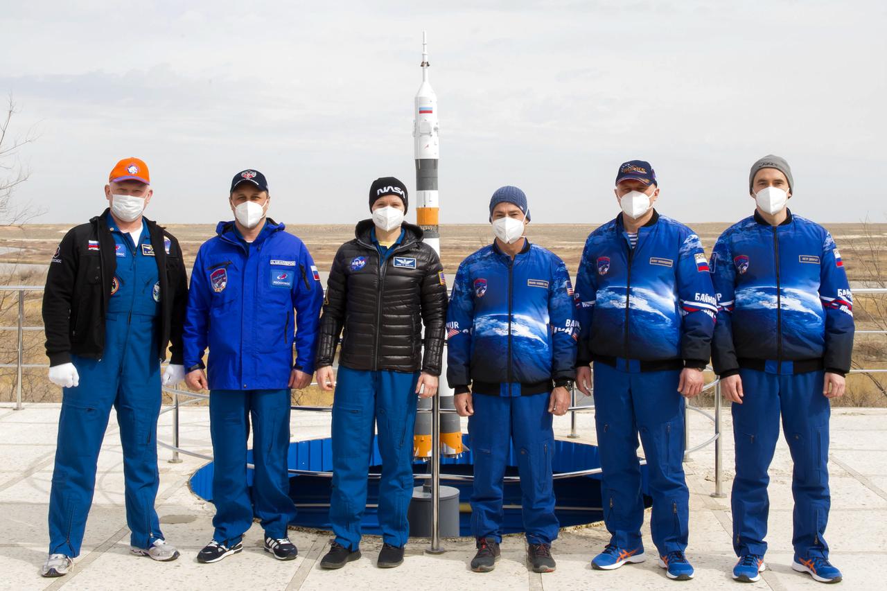 From left to right, Expedition 65 backup crew members Russian cosmonauts Oleg Artemyev and Anton Shkaplerov of Roscosmos, and NASA astronaut Anne McClain, pose for a photo with Expedition 65 prime crew members, NASA astronaut Mark Vande Hei, and Russian cosmonauts Oleg Novitskiy and Pyotr Dubrov of Roscosmos, after a tree planting ceremony that is part of traditional pre-launch activities, Saturday, April 3, 2021, in Baikonur, Kazakhstan. Vande Hei, Novitskiy and Dubrov are scheduled to launch to the International Space Station aboard the Soyuz MS-18 spacecraft on April 9. Photo Credit: (NASA/GCTC/Irina Spector)