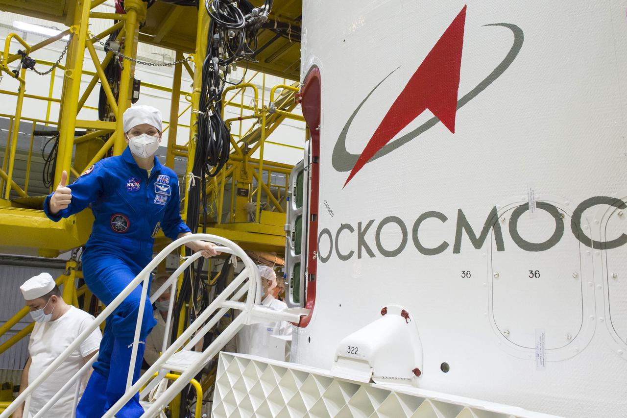 Expedition 65 backup crew member NASA astronaut Anne McClain, gives a thumbs up as she climbs inside the Soyuz MS-18 spacecraft during a final fit check with fellow Russian cosmonauts Anton Shkaplerov of Roscosmos, and Oleg Artemyev of Roscosmos, Sunday, April 4, 2021 at the Baikonur Cosmodrome in Kazakhstan. The prime crew is scheduled to launch to the International Space Station on a Soyuz rocket April 9. Photo Credit: (NASA/GCTC/Irina Spector)