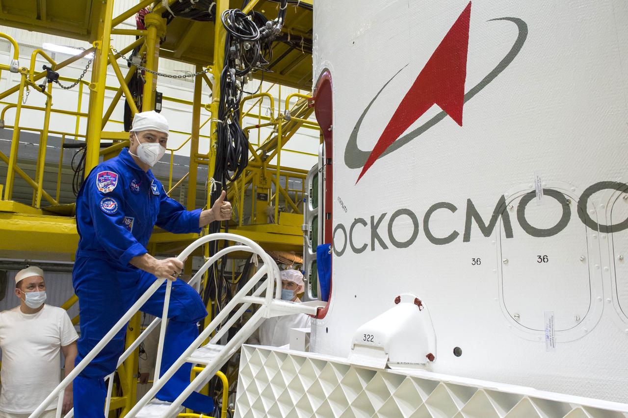 Expedition 65 prime crew member NASA astronaut Mark Vande Hei, gives a thumbs up as he climbs inside the Soyuz MS-18 spacecraft during the final fit check to prepare for launch with fellow Russian cosmonauts Oleg Novitskiy and Pyotr Dubrov of Roscosmos, Sunday, April 4, 2021 at the Baikonur Cosmodrome in Kazakhstan. The trio are scheduled to launch to the International Space Station on a Soyuz rocket April 9. Photo Credit: (NASA/GCTC/Irina Spector)
